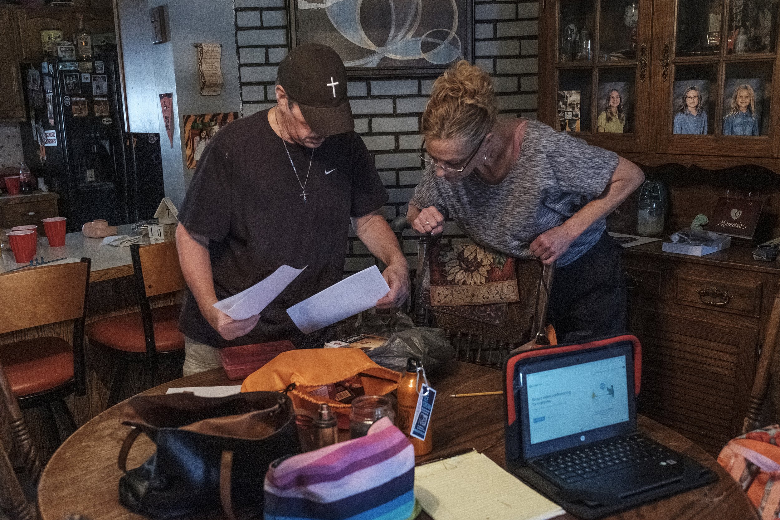Greg and Traci check over the girls’ school work. They went through this during COVID, but it’s different this time because there’s less support from teachers.
