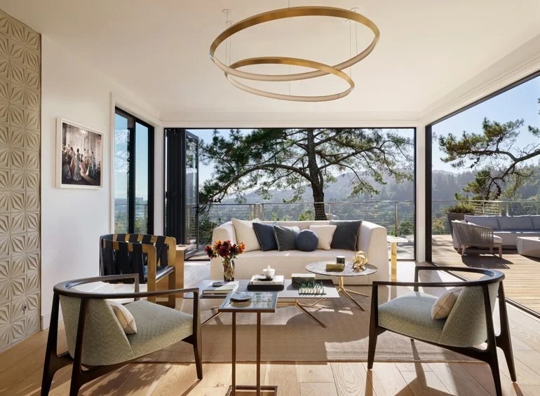 Stylish living room with mountain views, designed by Julie Rootes Interiors, highlighting comfort and natural beauty.