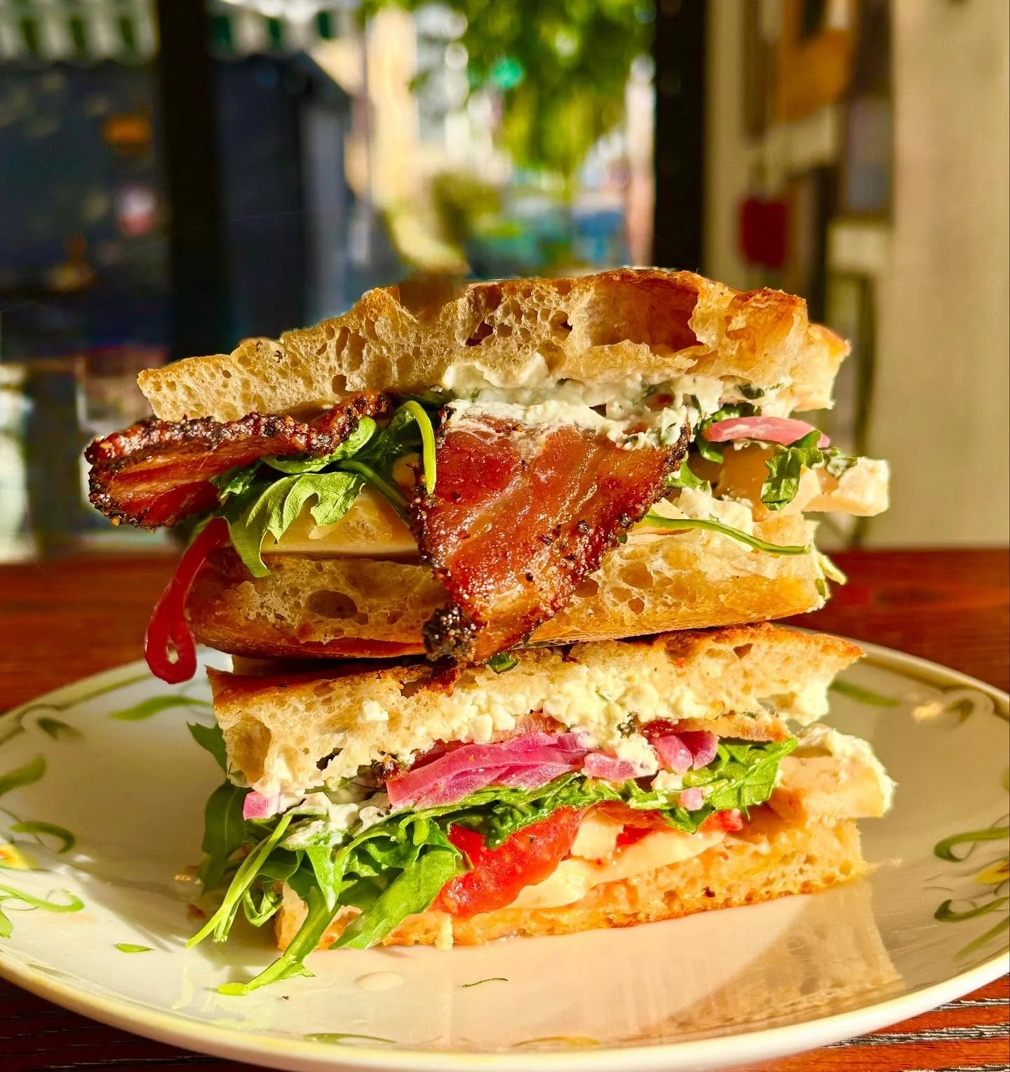 Our new Chicken and Bacon Sandwich with feta ranch, tomato, arugula and pickled red onion all on our house baked lemon thyme focaccia! Tangy, bright, and protein packed!