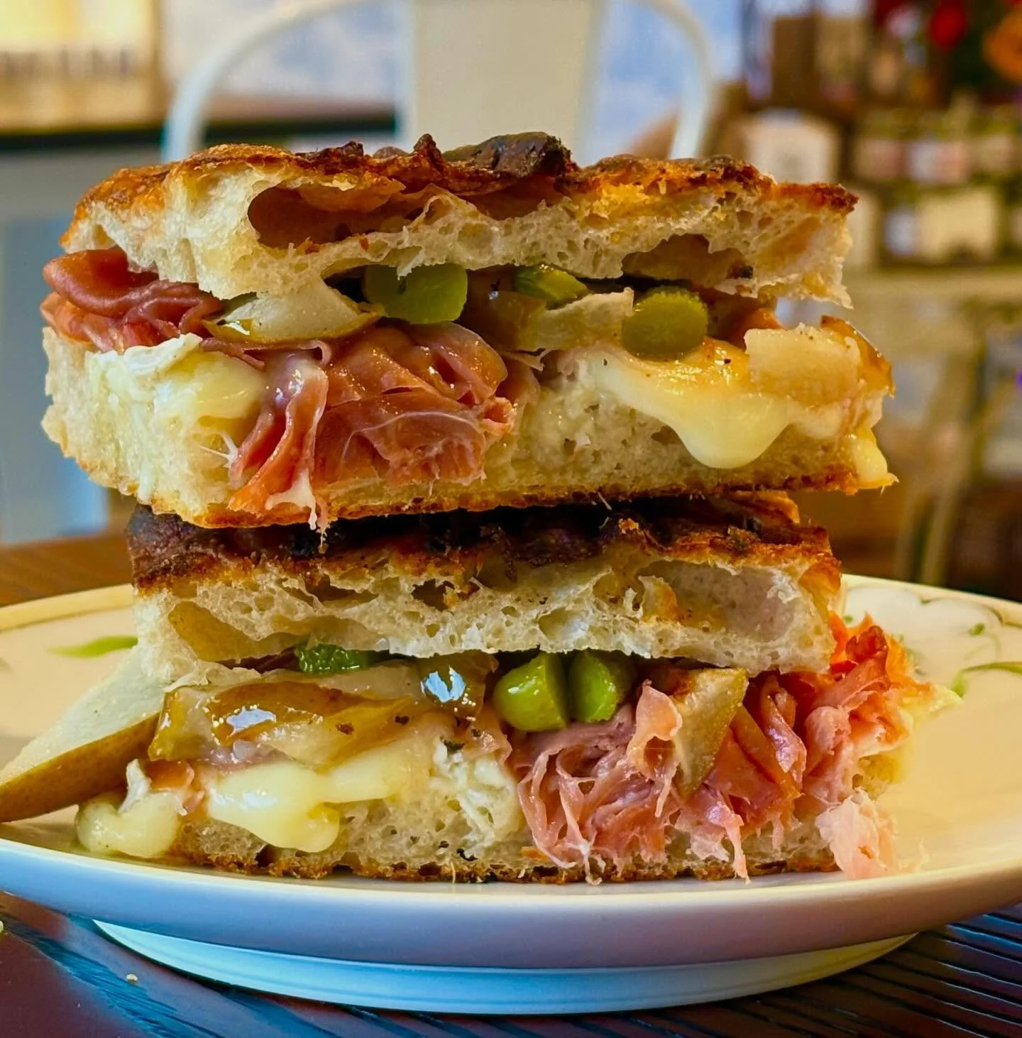 🎉New sandwich alert!🎉 Prosciutto and Pear Sandwich with Brie, cornichons, and chili oil and red onion house baked focaccia