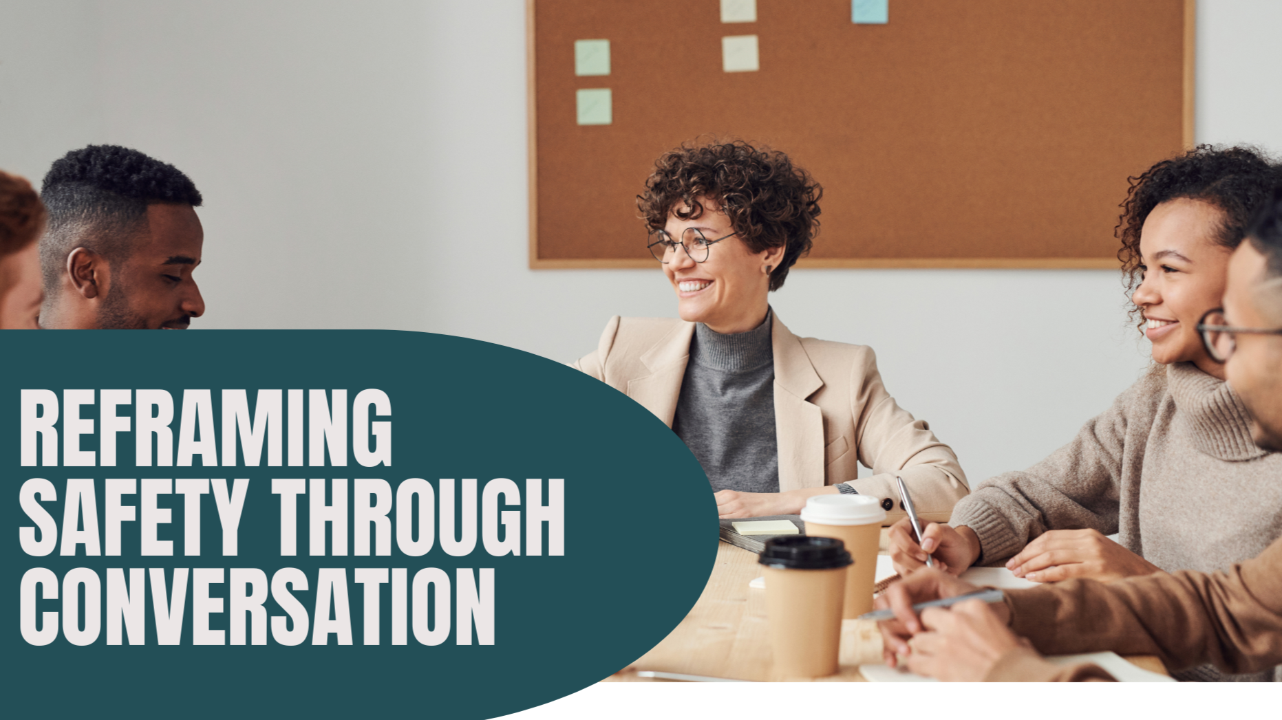 A group of diverse young adults and a woman with glasses smiling and having a conversation at a table in an office environment, with a corkboard on the wall behind them. The image features the text 'Reframing Safety Through Conversation' over a dark green shape in the lower left corner.