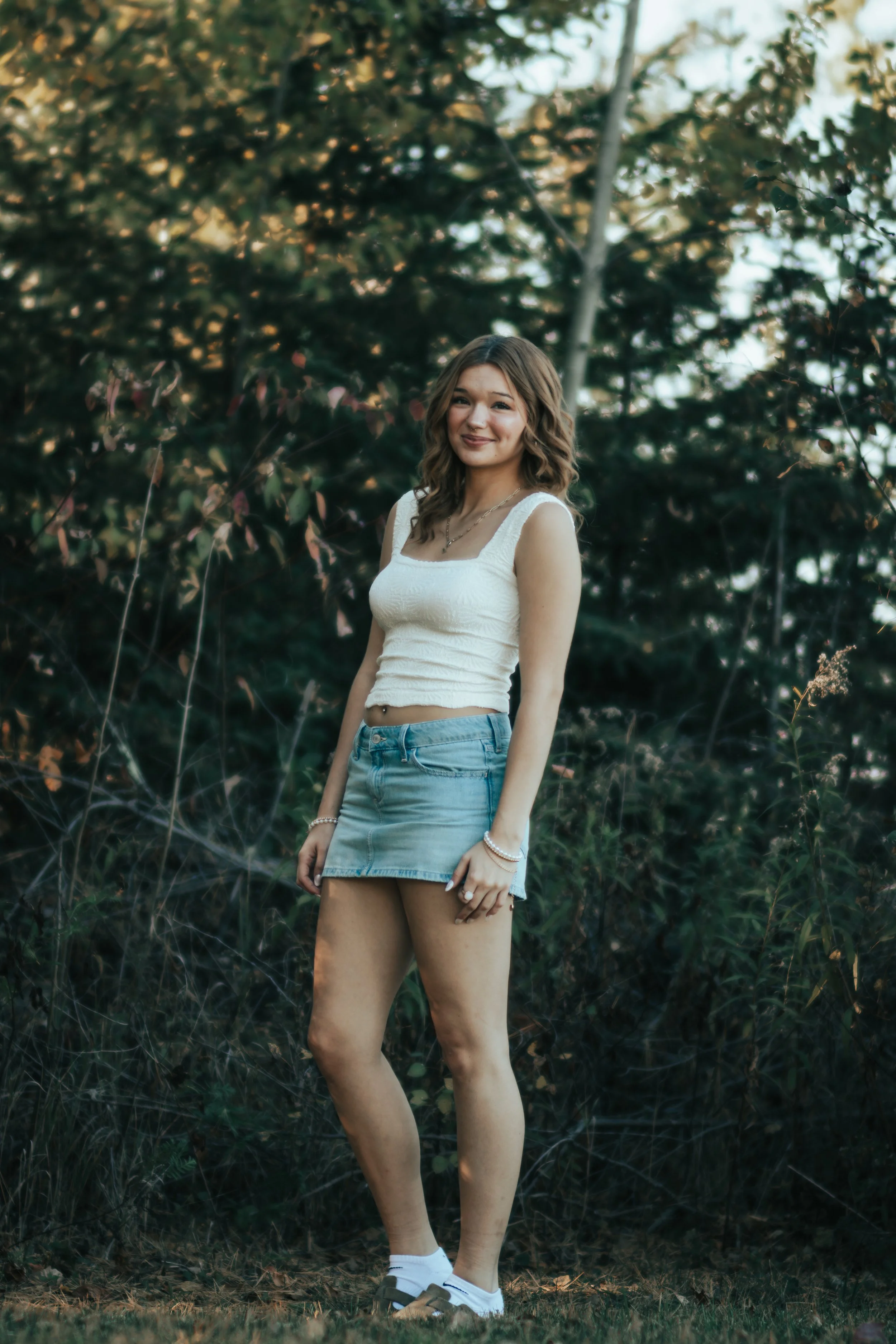 Alternate senior portrait of the same Red Cliff Nation young woman, captured outdoors with a relaxed, storytelling style.