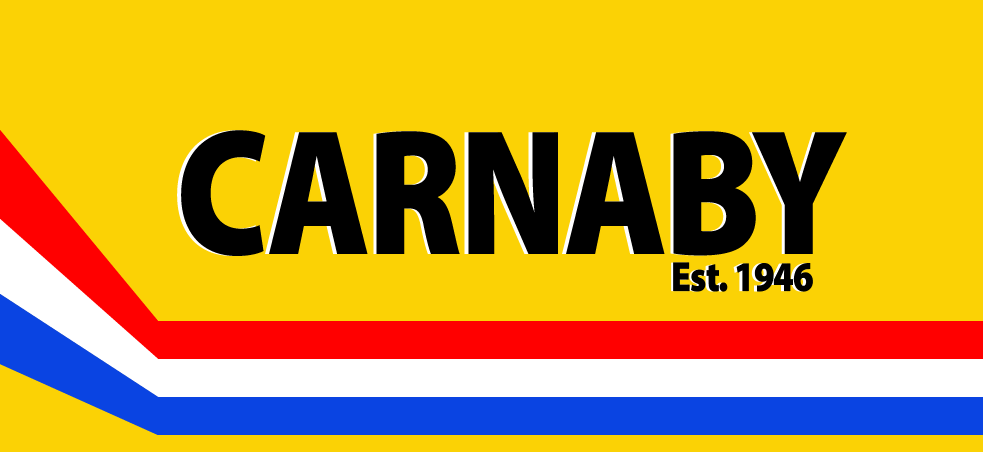 Bright yellow background with bold black text reading 'CARNABY' and 'Est. 1946'. Red, white, and blue stripes at the bottom.