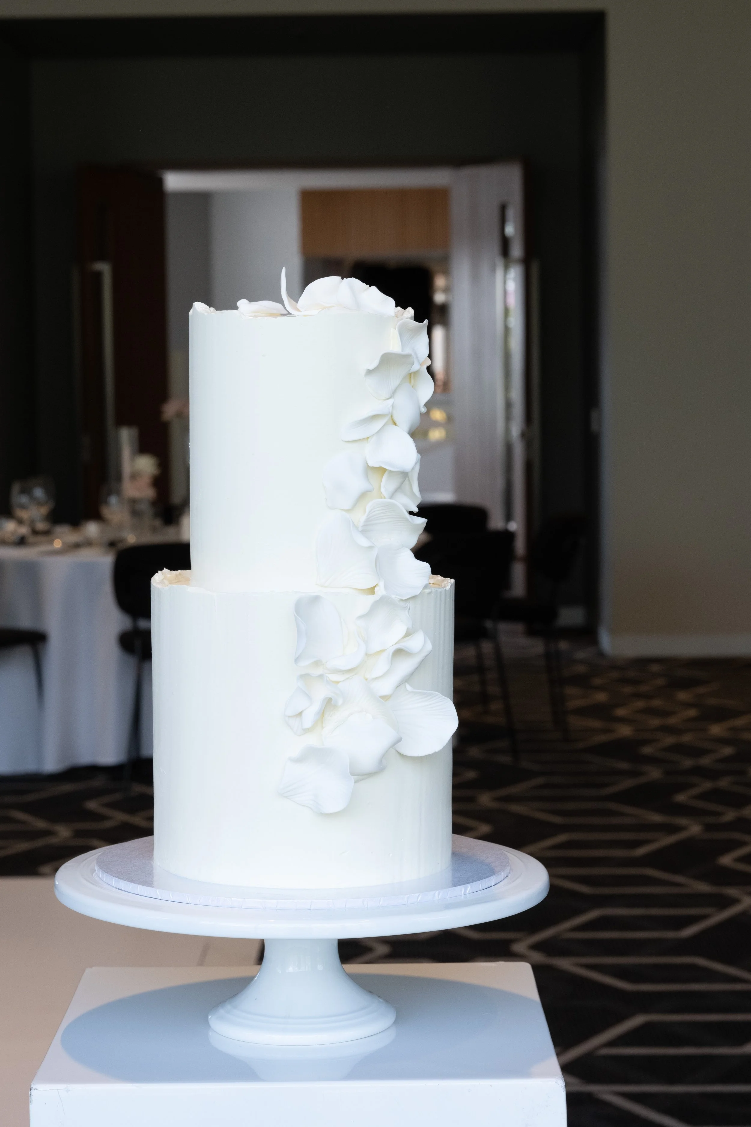 two tier wedding, buttercream wedding cake, organic edging, cascading petals, fondant petals, White Wedding, Minimalist design, luxe wedding cake