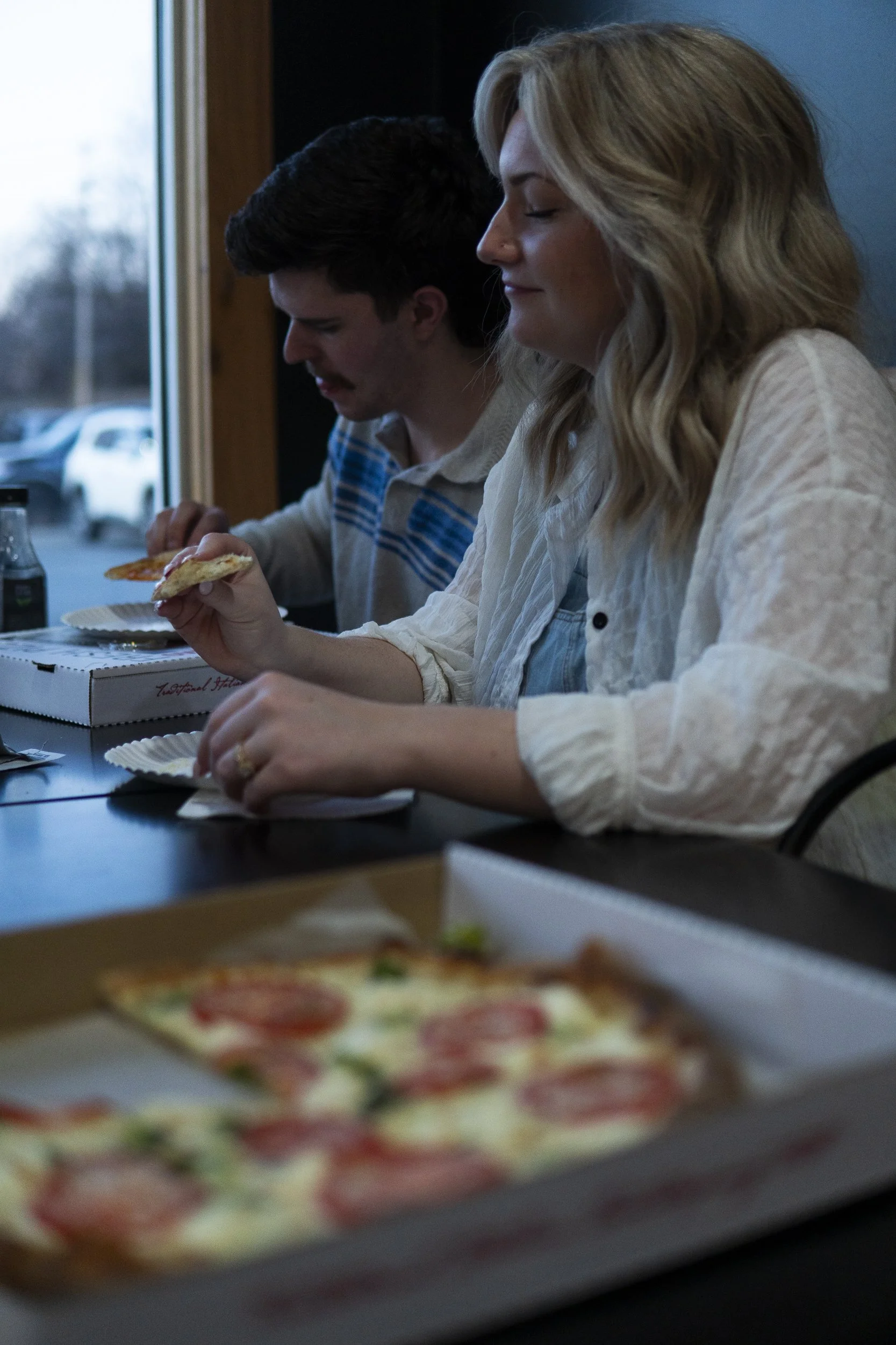 a young couple enjoying their sourdough pizza in the sourdough pizza pizzeria in Forest, Va