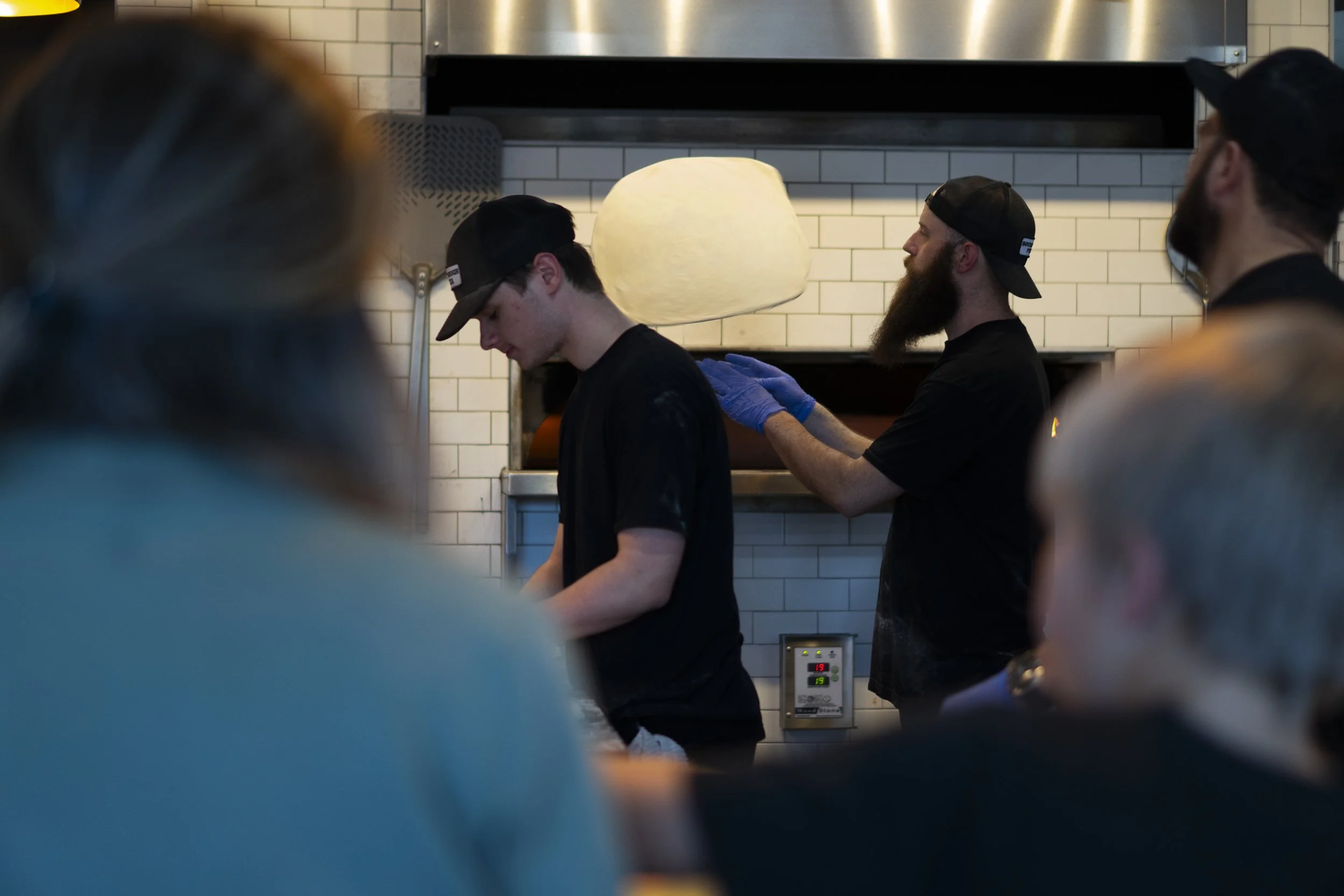 sourdough pizza company employees preparing dough for cooking