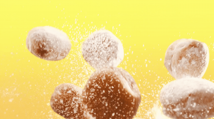 a group of donuts flying through the air.gif