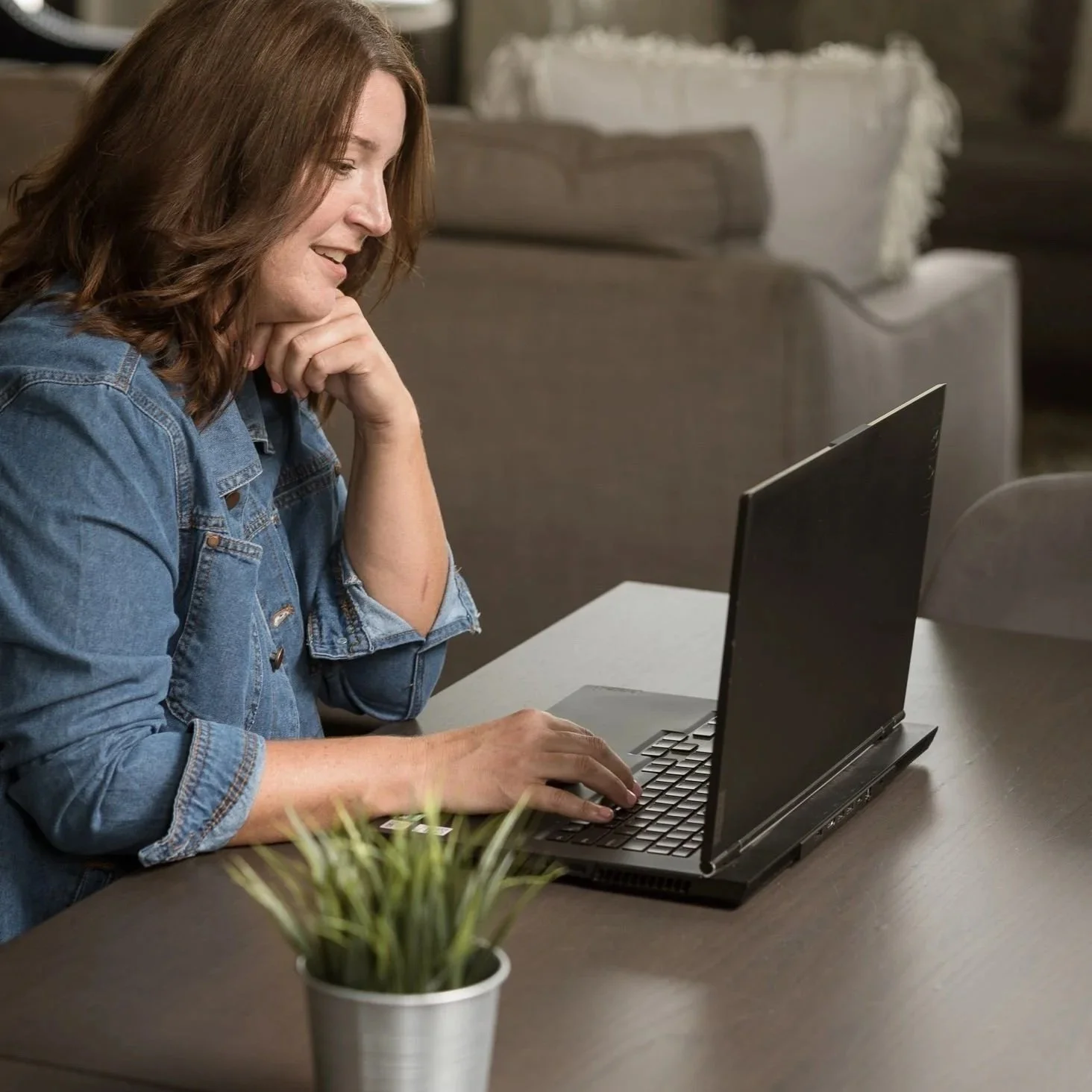 A digital accessibility specialist auditing a website on a alptop in a modern office.