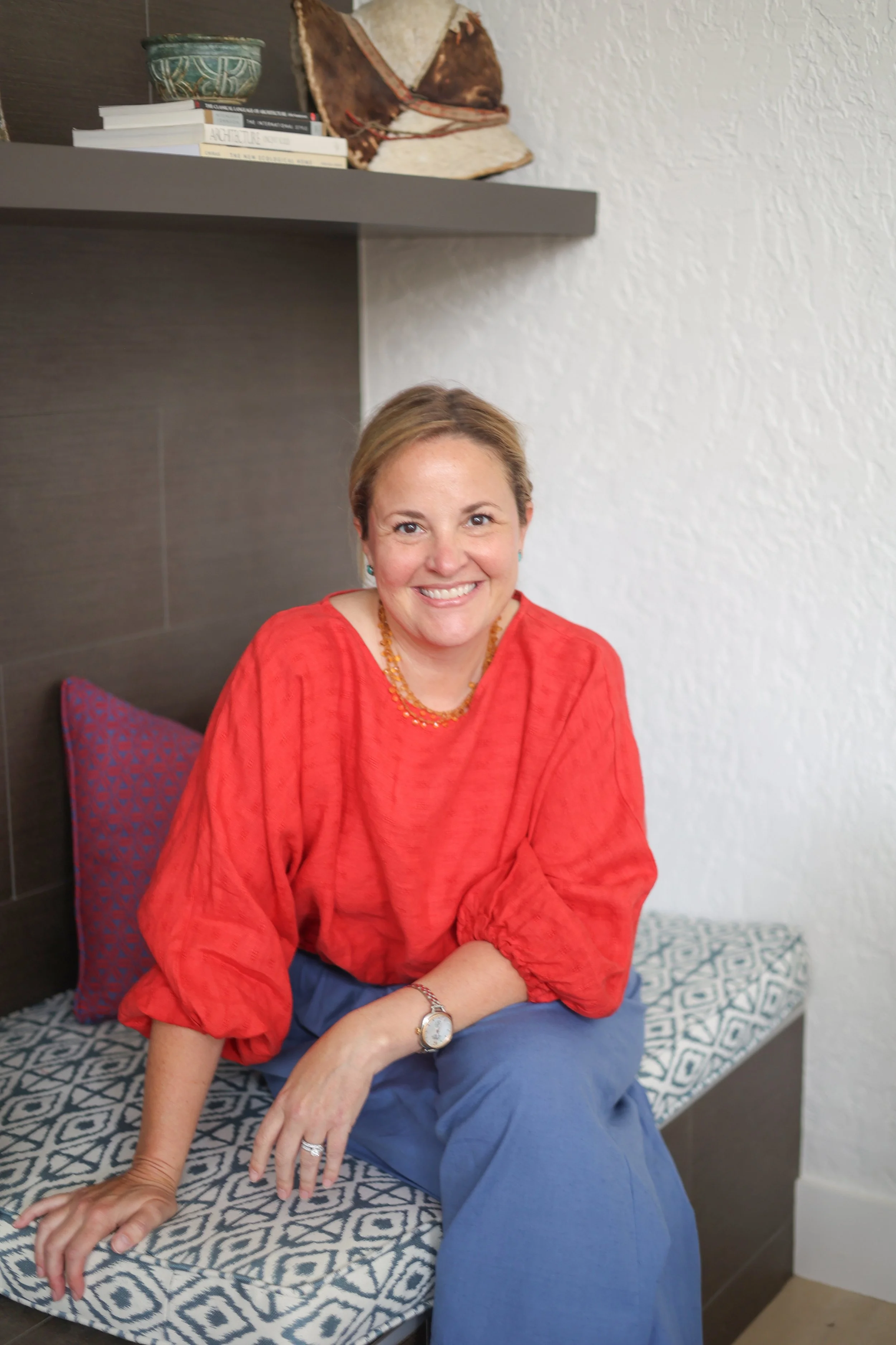 Designer in her client's home with custom upholstery.