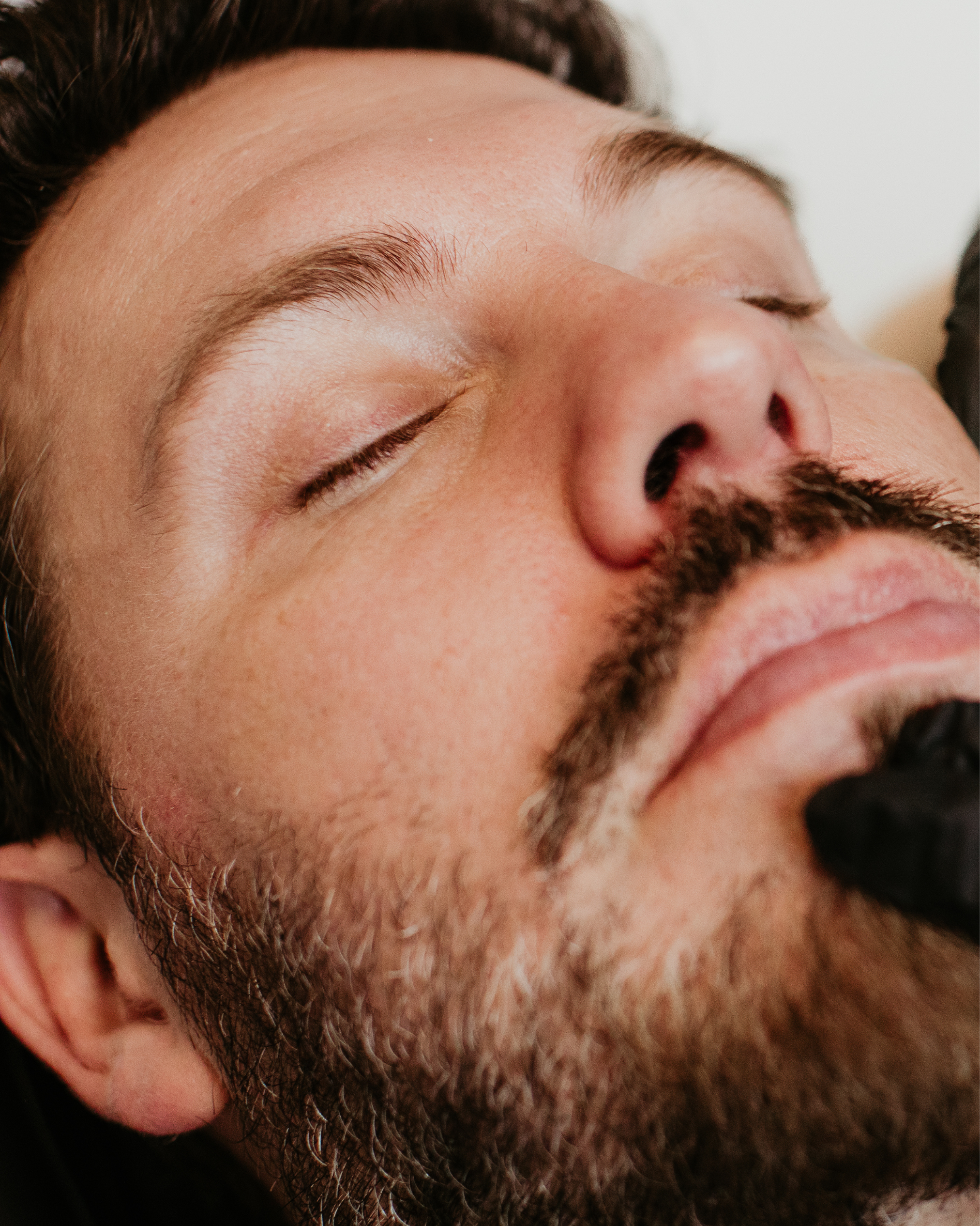 Male patient relaxed during a facial skin treatment at Sona Medical Aesthetics Newcastle WA
