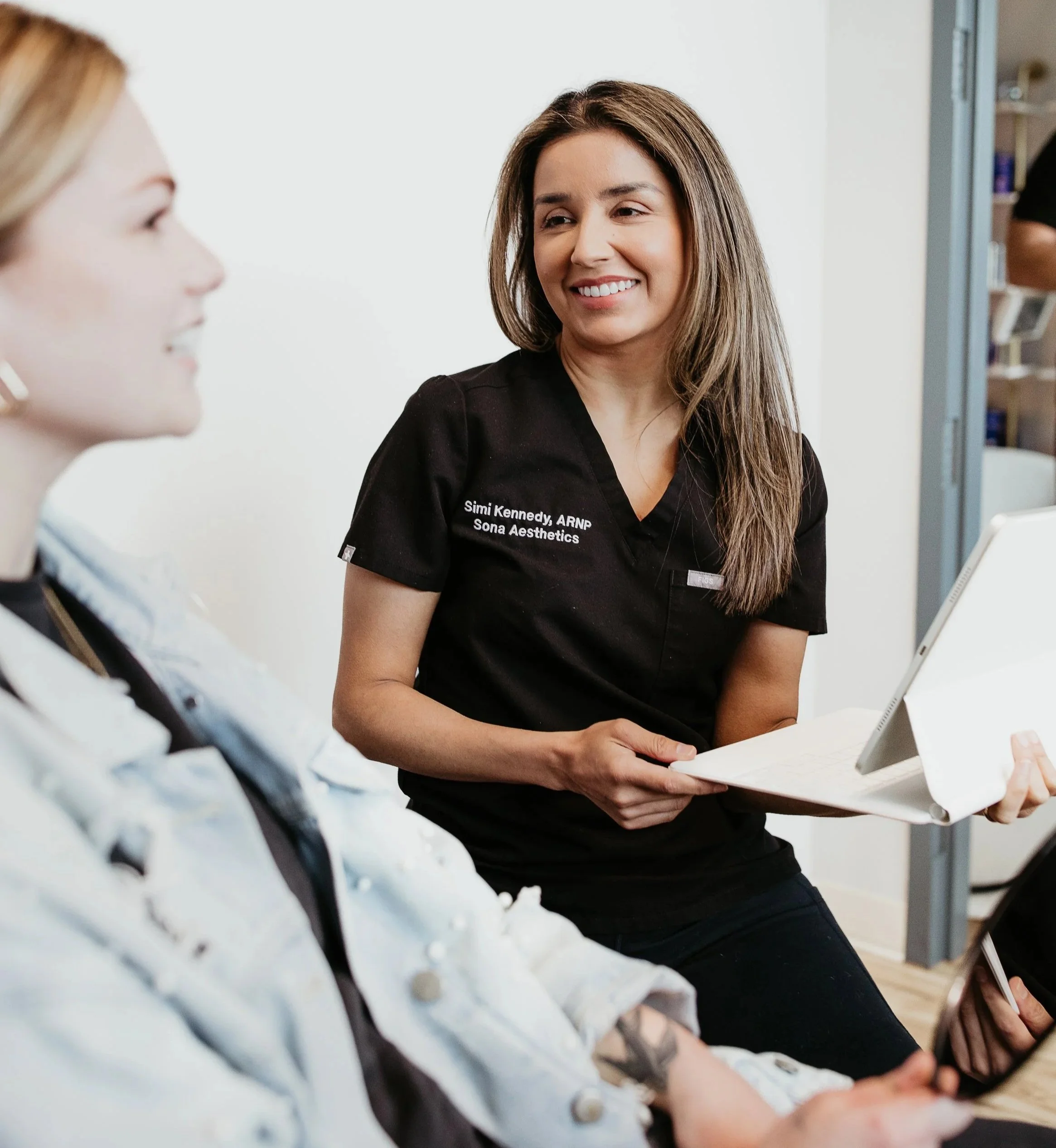 Provider discussing weight loss and metabolic health goals with a patient at Sona Medical Aesthetics Newcastle WA