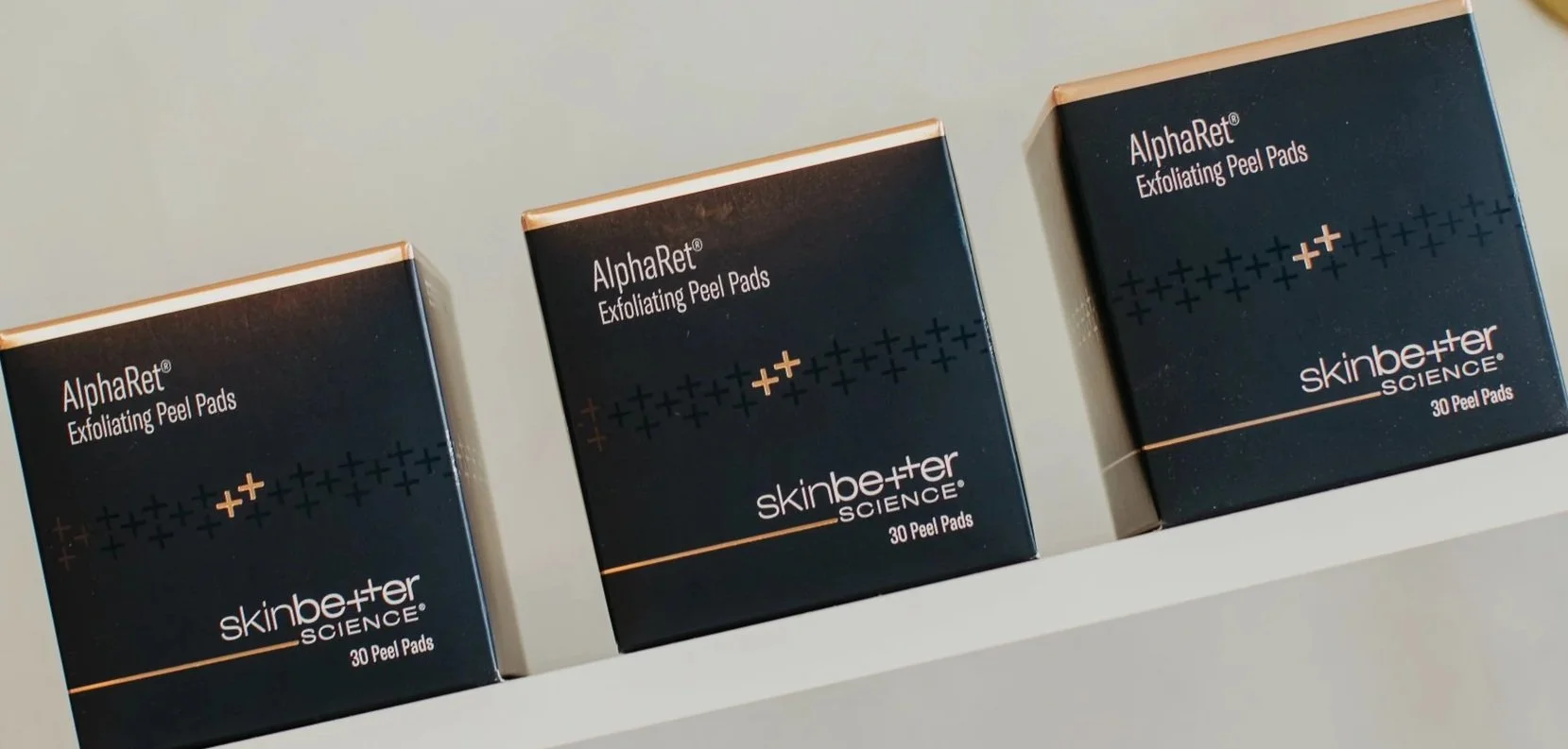 Three boxes of SkinBetter Science AlphaRet Exfoliating Peel Pads displayed on a shelf at Sona Medical Aesthetics Newcastle WA