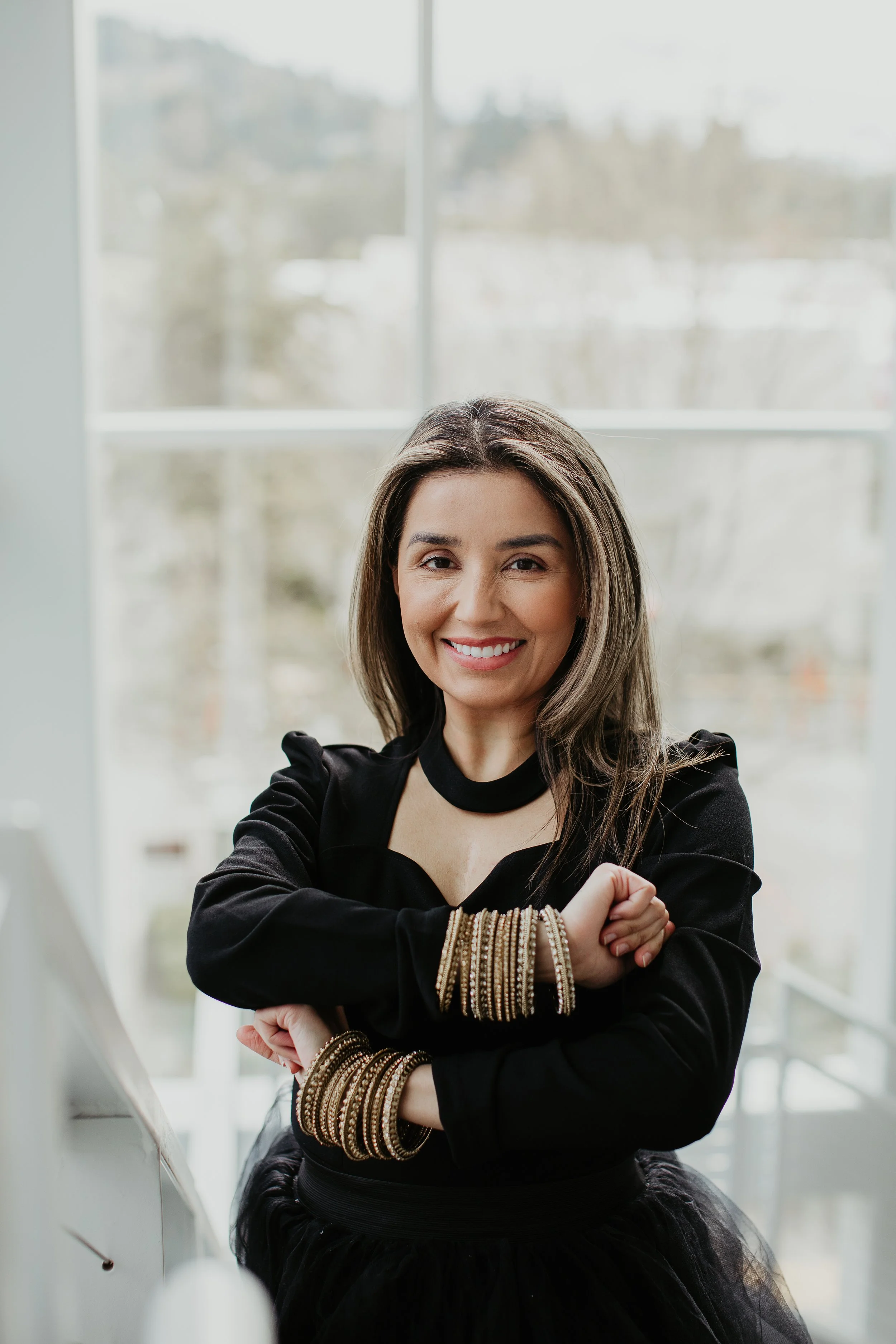 Simi Kennedy founder of Sona Medical Aesthetics wearing gold bangles in a brand portrait Newcastle WA