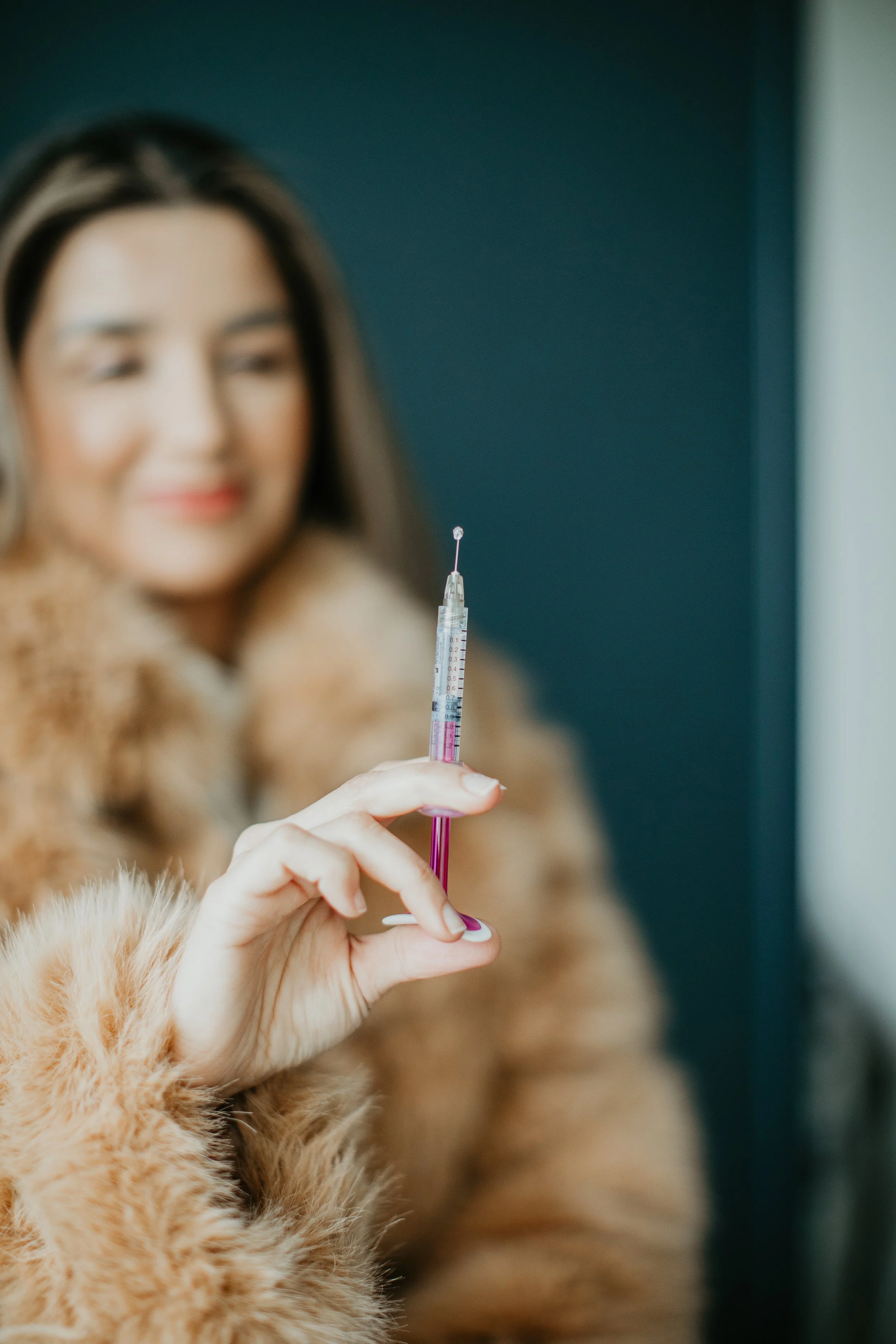 Simi Kennedy ARNP holding a dermal filler syringe at Sona Medical Aesthetics boutique med spa Newcastle WA