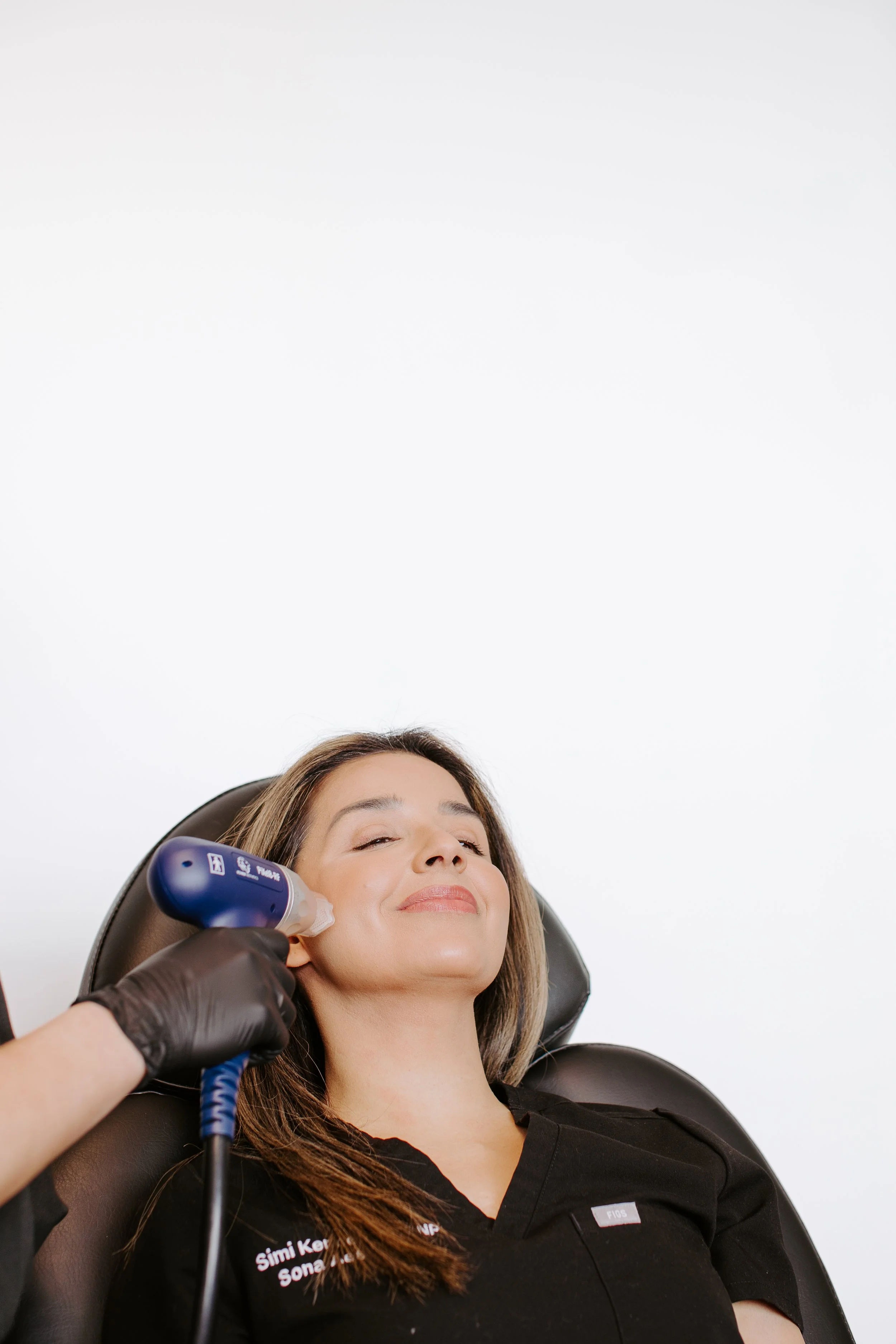 Provider performing RF microneedling for skin texture improvement and pore tightening at Sona Medical Aesthetics Newcastle WA