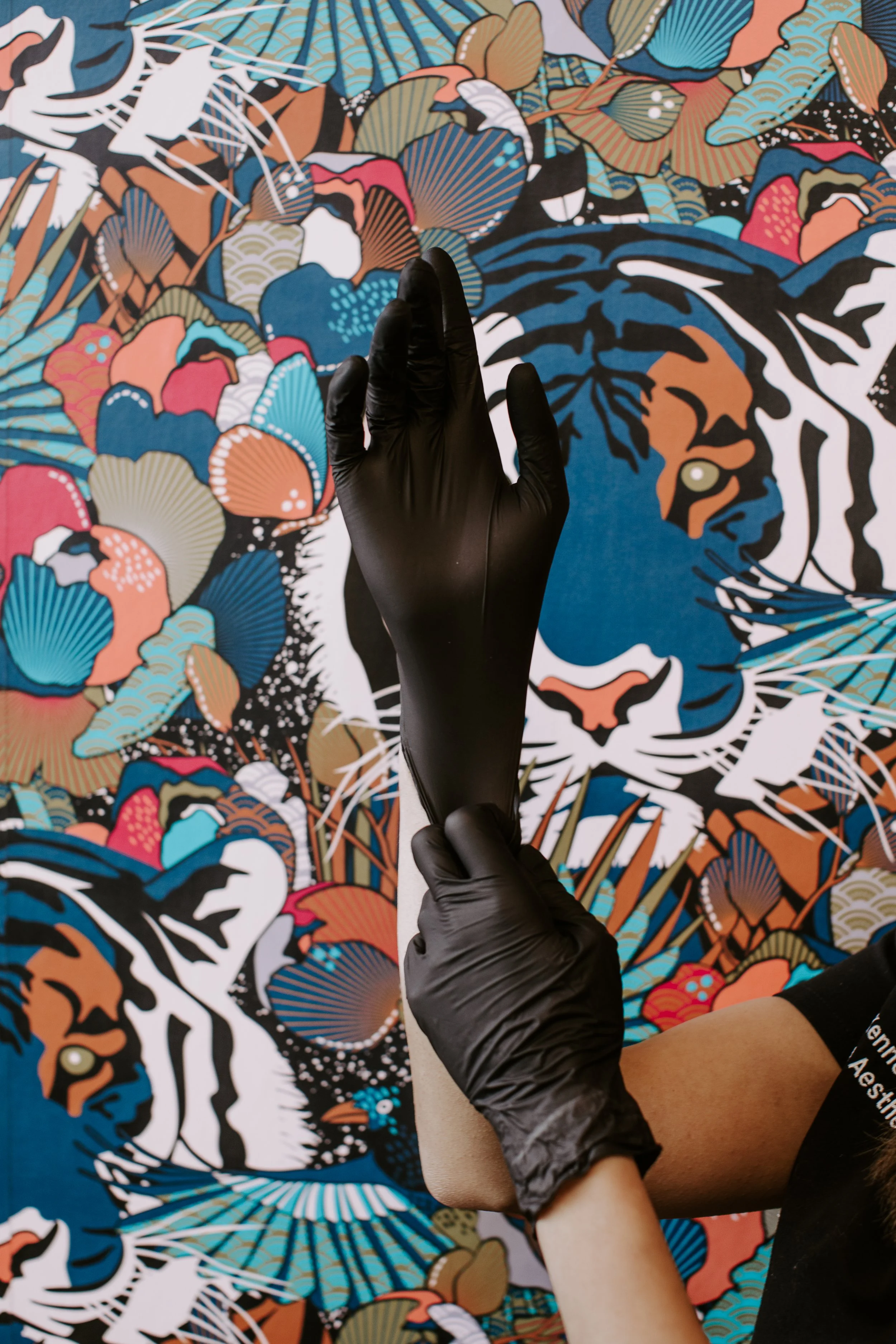 Simi Kennedy ARNP raising both gloved hands before an aesthetic treatment at Sona Medical Aesthetics Newcastle WA