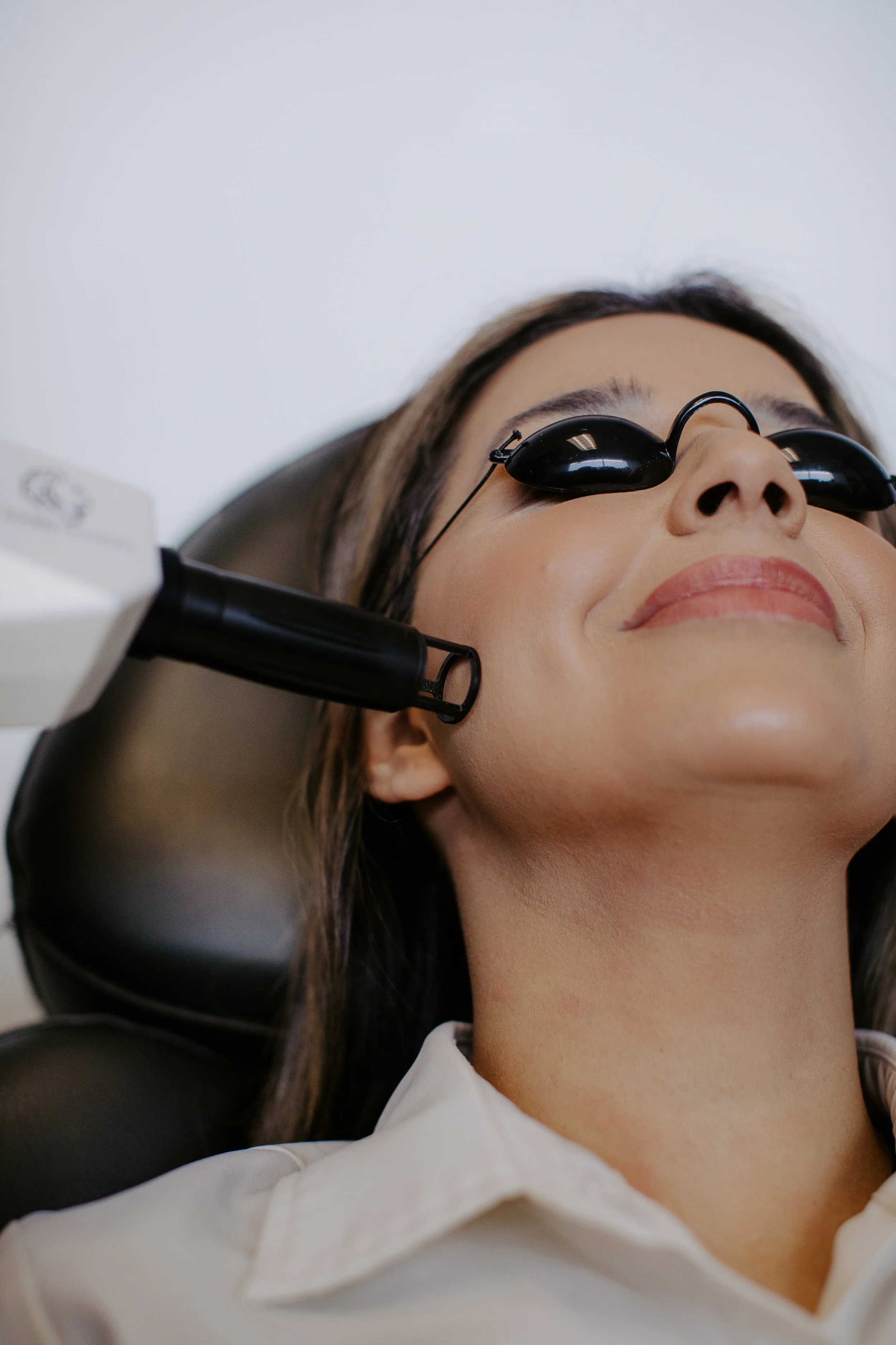 Patient wearing protective eye shields during an Erbium laser resurfacing treatment for skin laxity at Sona Medical Aesthetics Newcastle WA