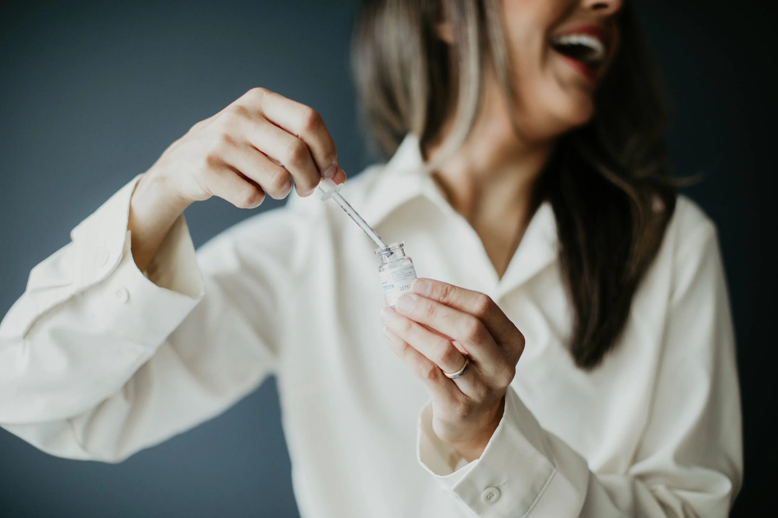 Provider drawing up an injectable treatment from a vial at Sona Medical Aesthetics Newcastle WA