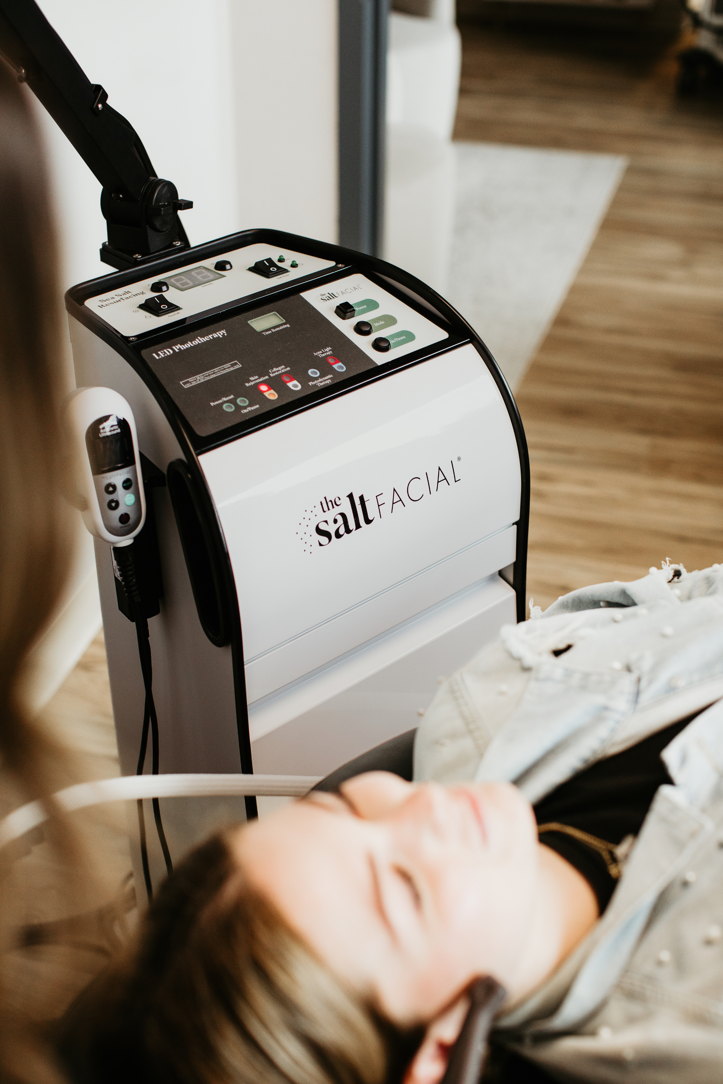 Provider performing the Salt Facial treatment with LED phototherapy on a relaxed patient at Sona Medical Aesthetics Newcastle WA