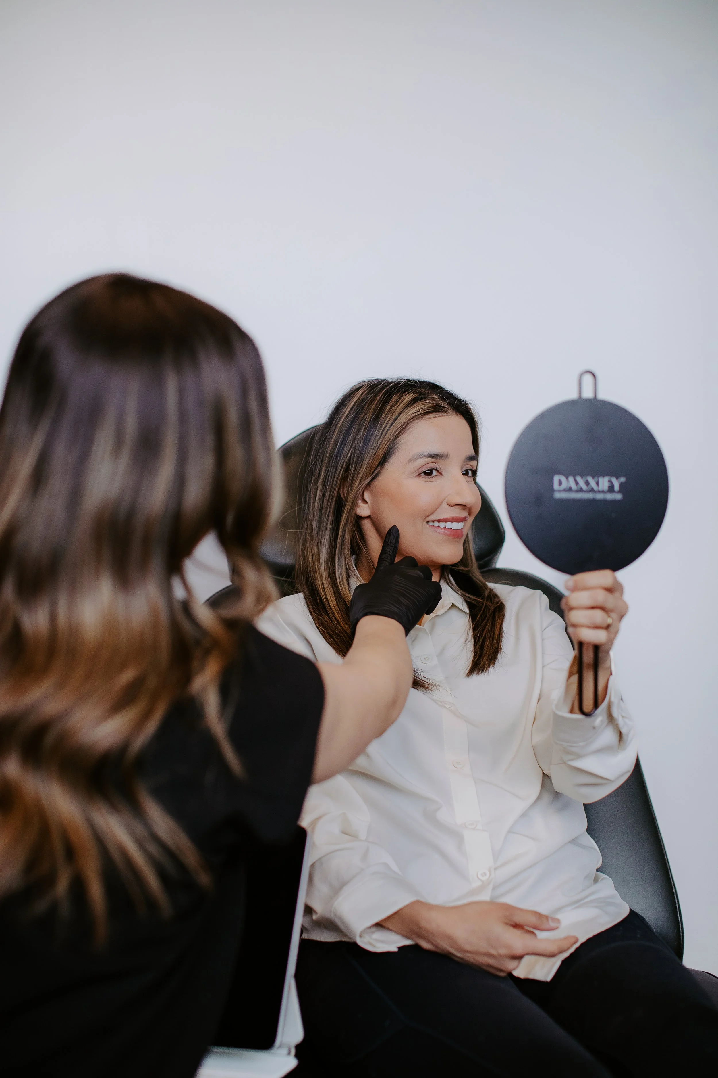 Provider reviewing skin tone and pigmentation with a patient during a consultation at Sona Medical Aesthetics Newcastle WA