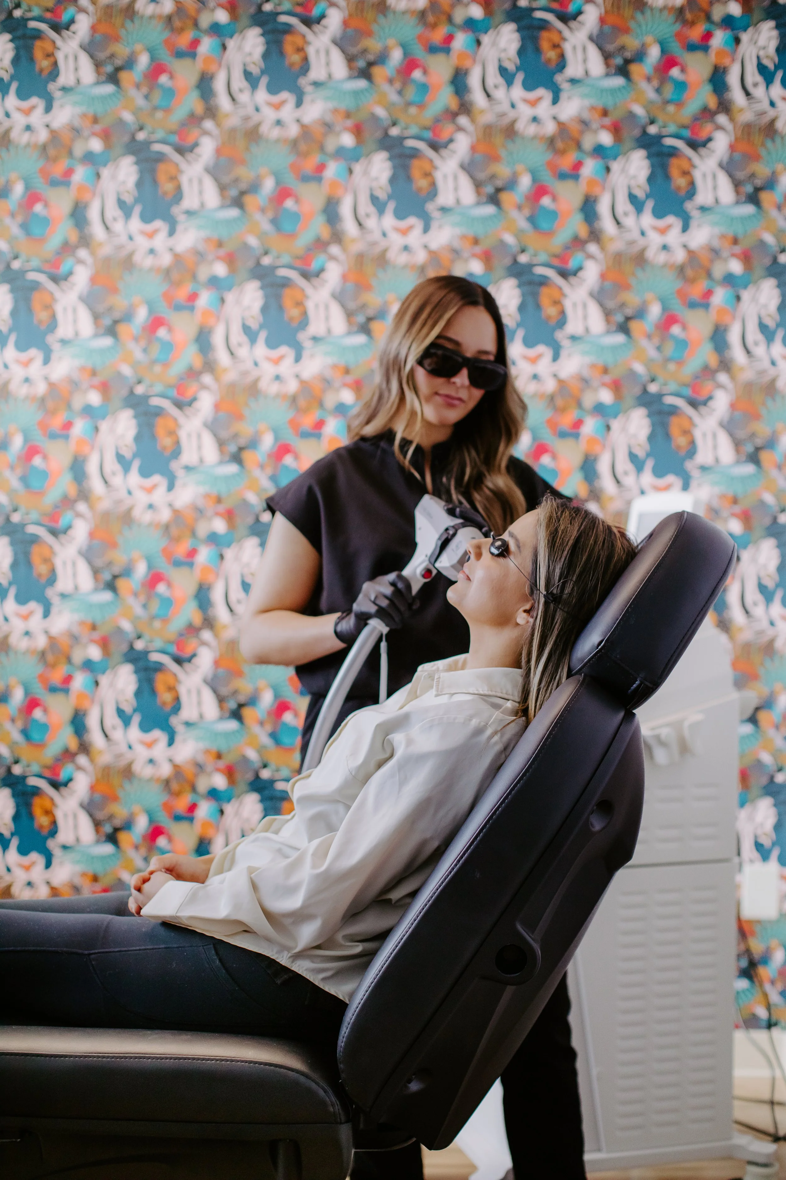 Provider performing IPL intense pulsed light acne and redness treatment at Sona Medical Aesthetics Newcastle WA