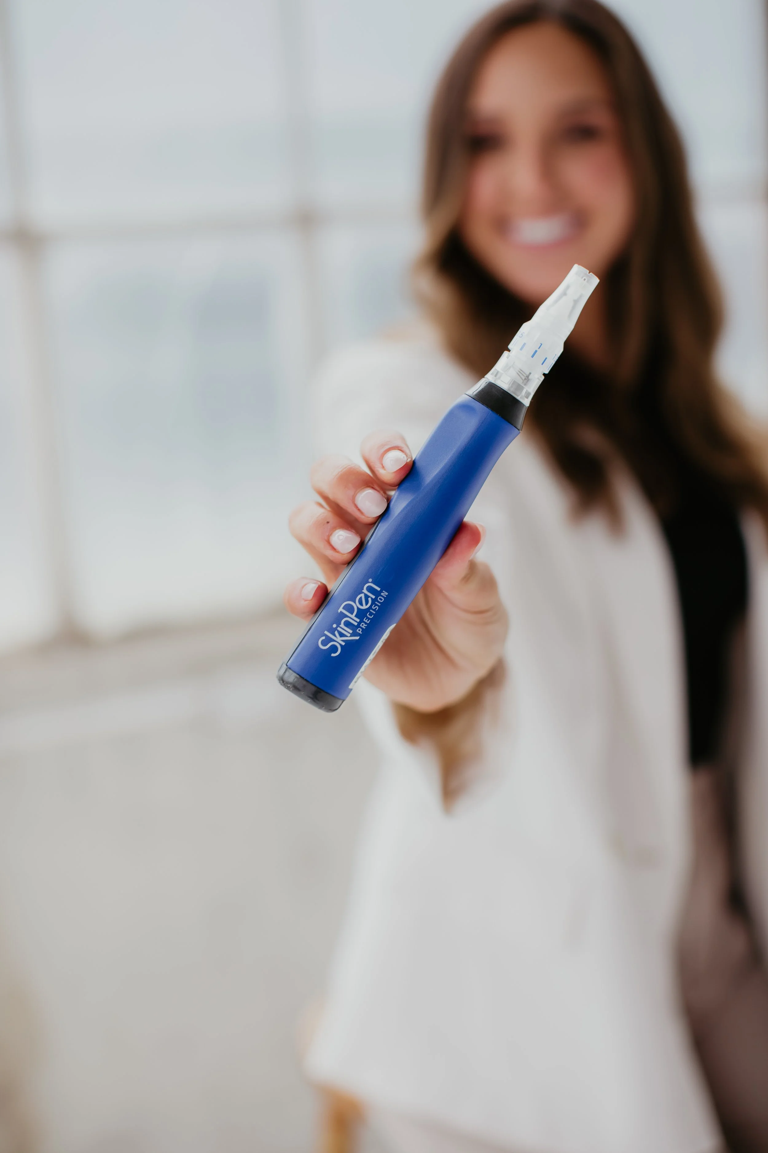 Mia Bauer licensed master esthetician holding a SkinPen Precision microneedling device at Sona Medical Aesthetics Newcastle WA