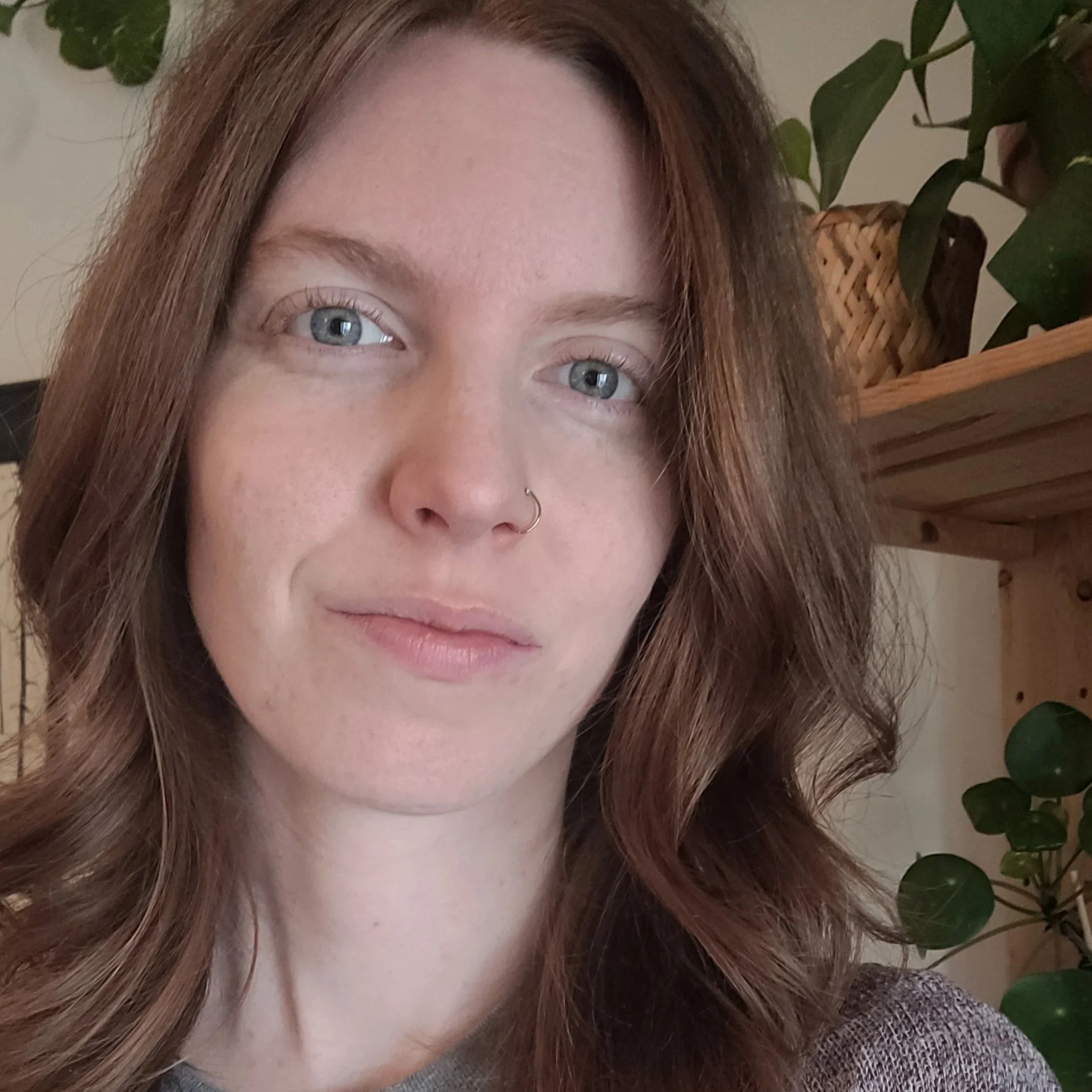 Headshot of a woman with reddish hair.