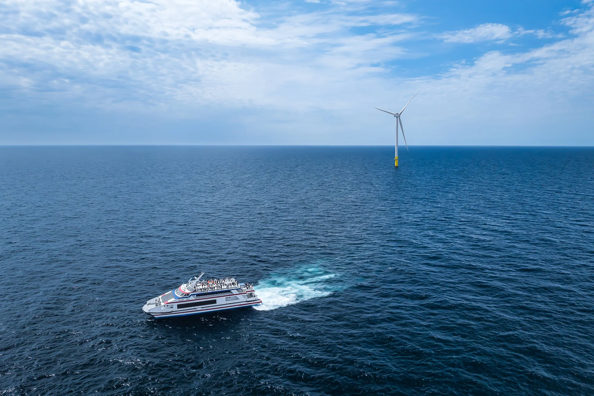 Cross Sound Ferry's Cecelia Ann carrying a wind farm tour toward a distant turbine.