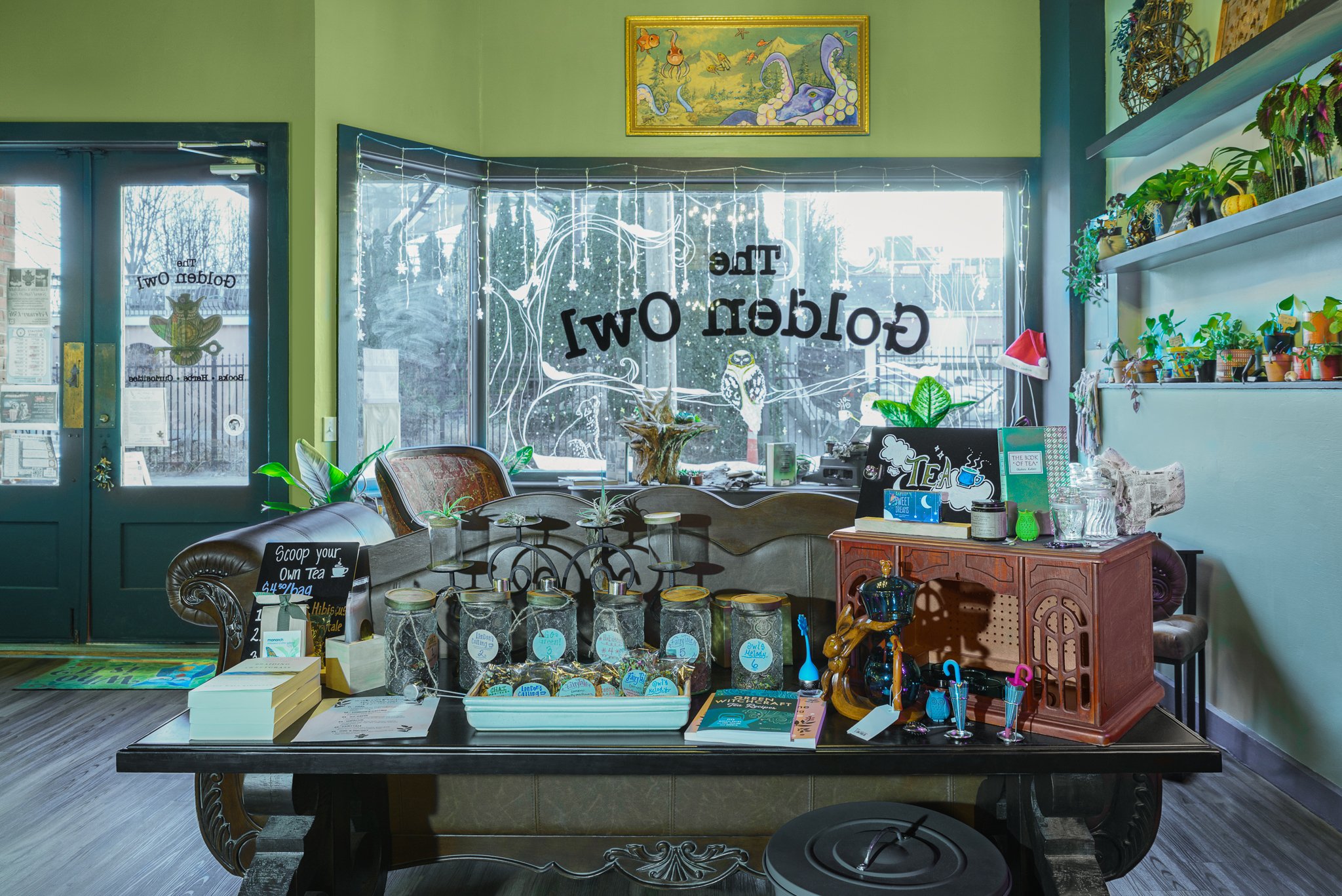 Tea bar with jars of loose leaf tea in front of the storefront windows.