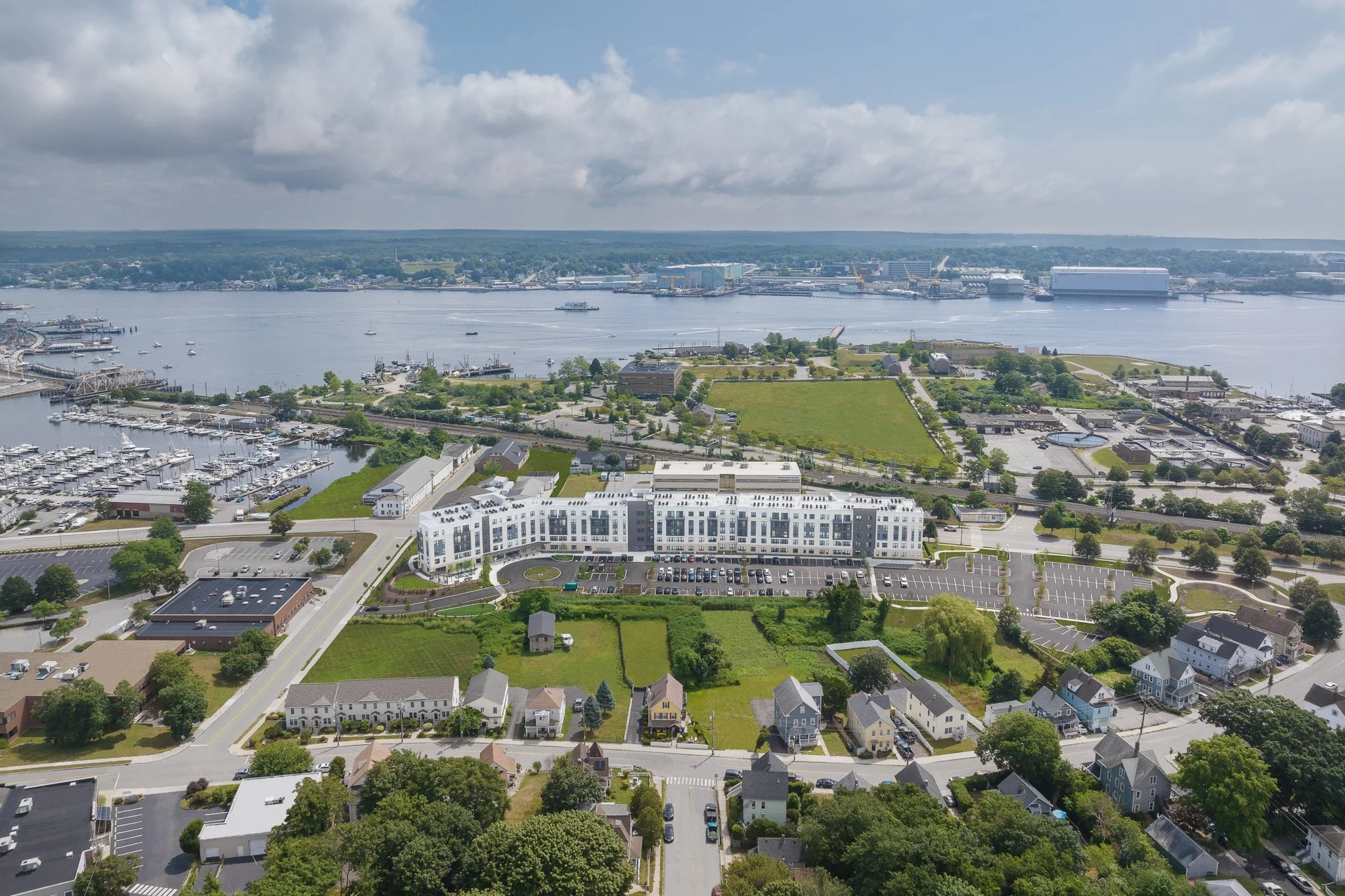 Aerial drone view of the building with a ferry crossing the Thames River.