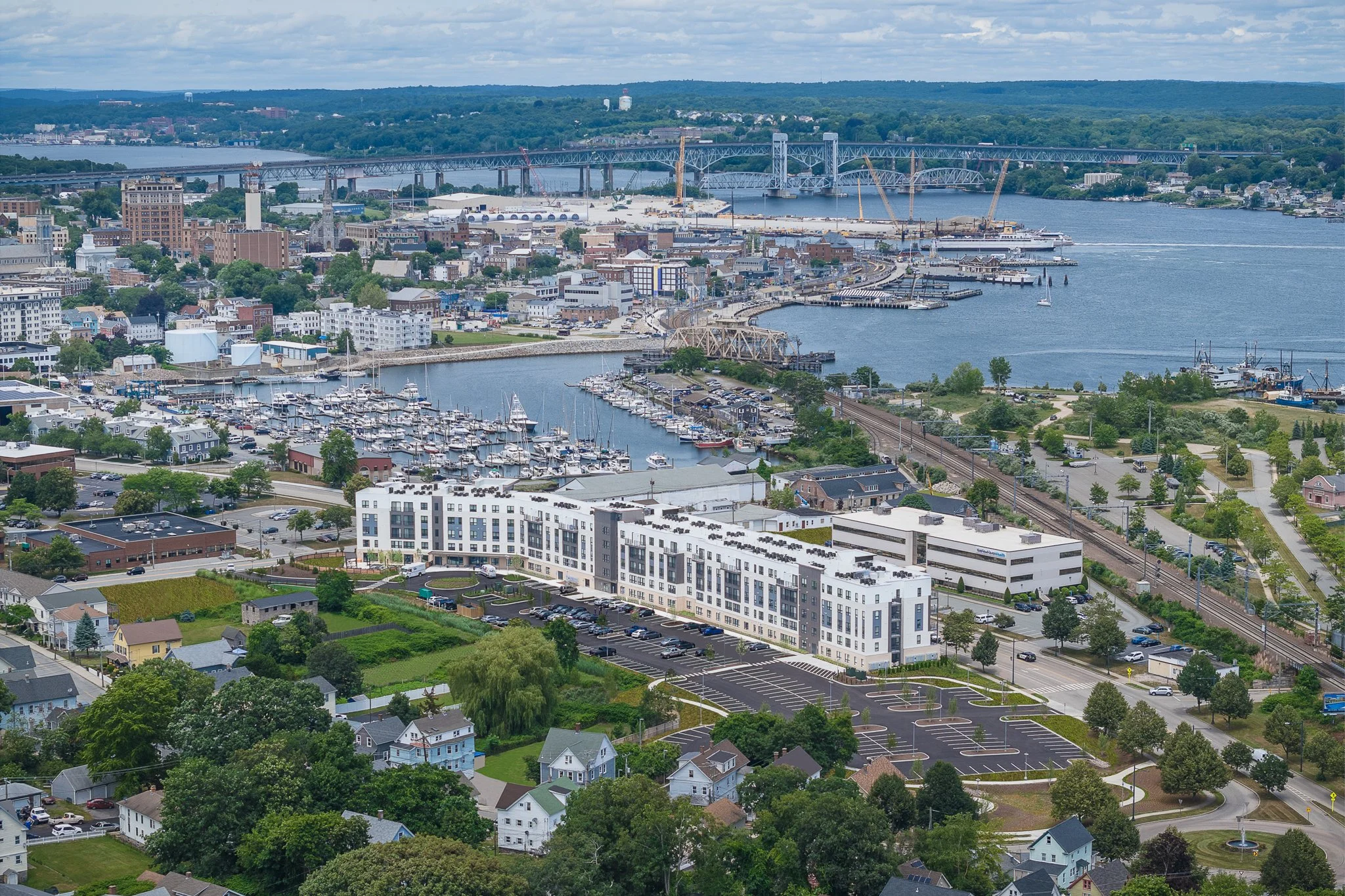 Aerial drone view of the building with downtown, the Thames River and State Pier behind it.