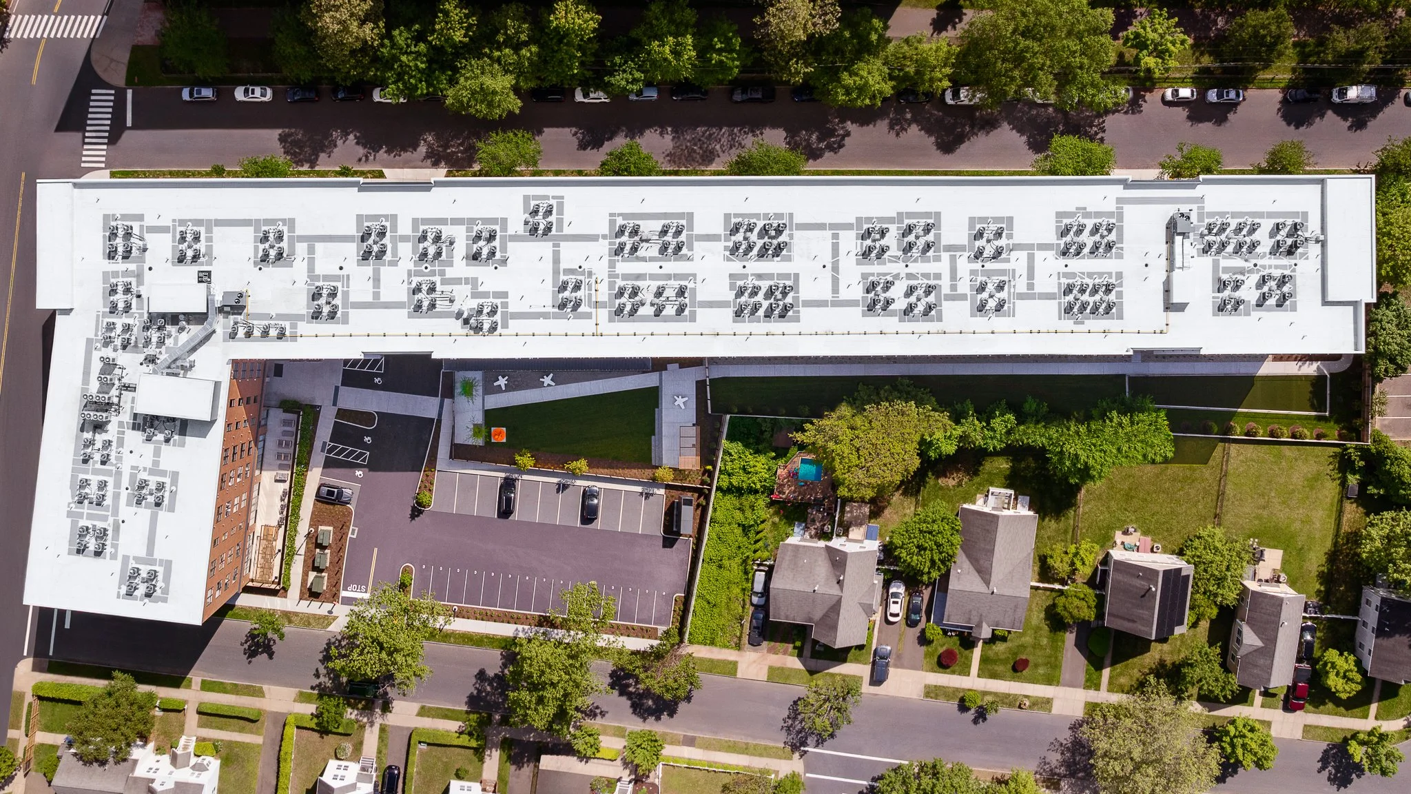 Overhead aerial drone view of the rooftop equipment, courtyard and parking.