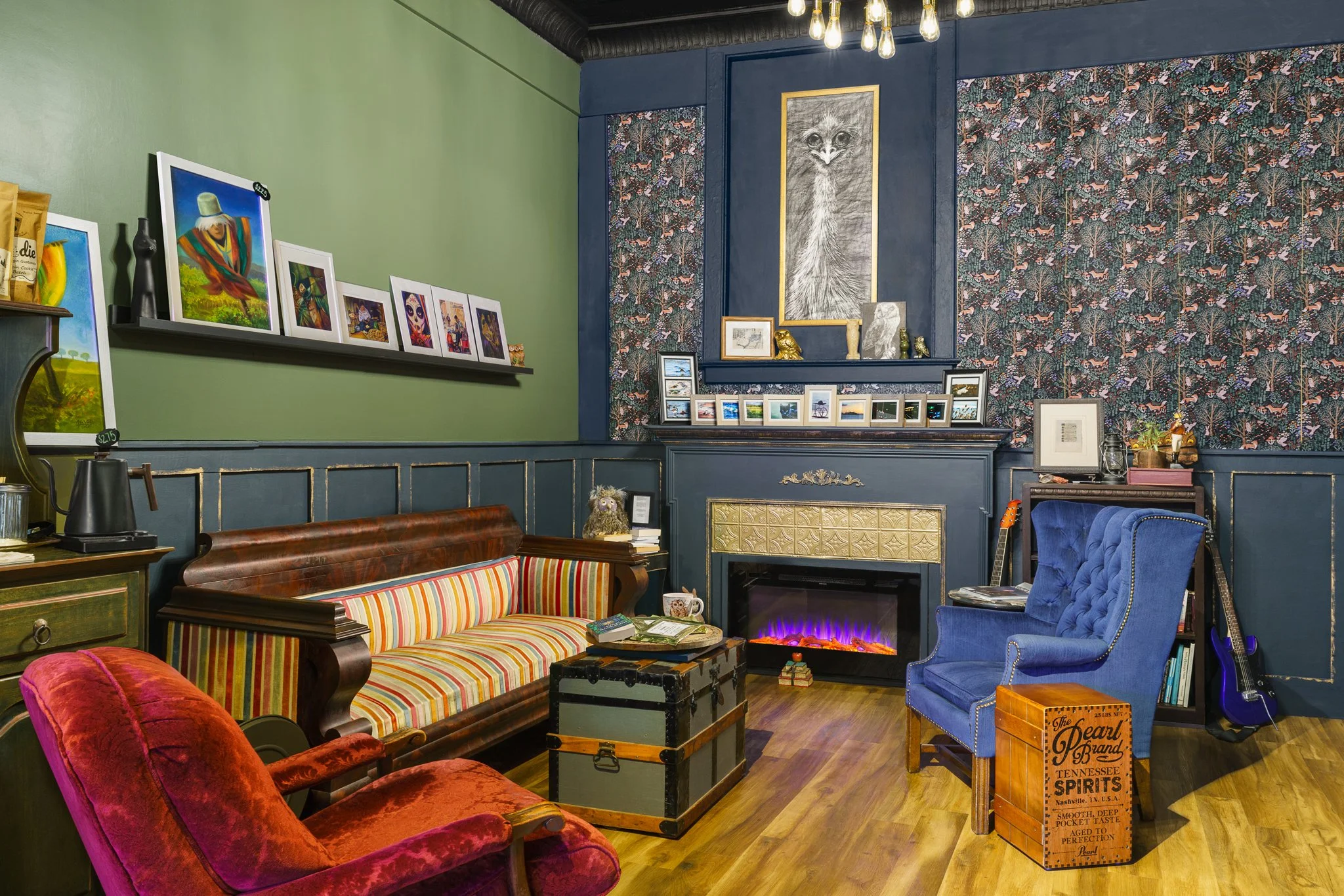 Fireplace lounge with a leather couch and velvet armchairs.