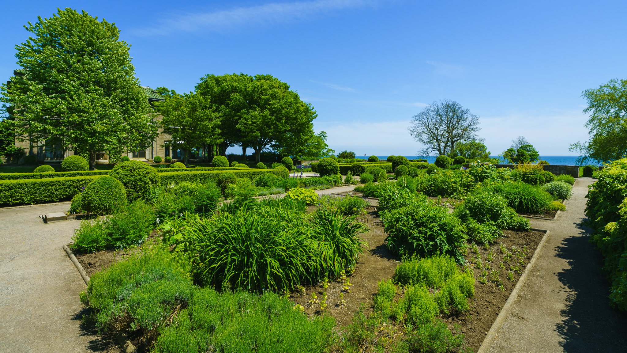 Garden beds and walking paths with Long Island Sound on the horizon.