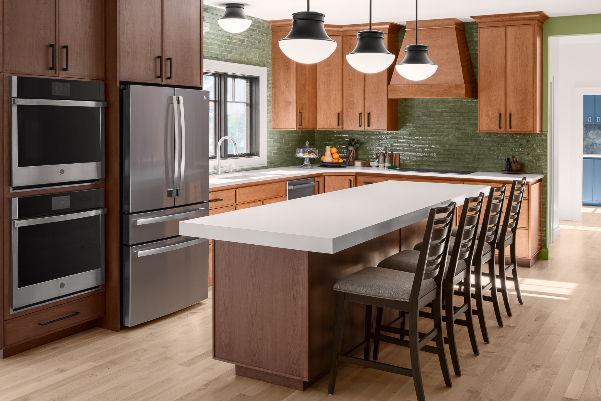 Interior kitchen, island with chairs, clean appliances, green backsplash tile, wood cabinets, Westerly, RI