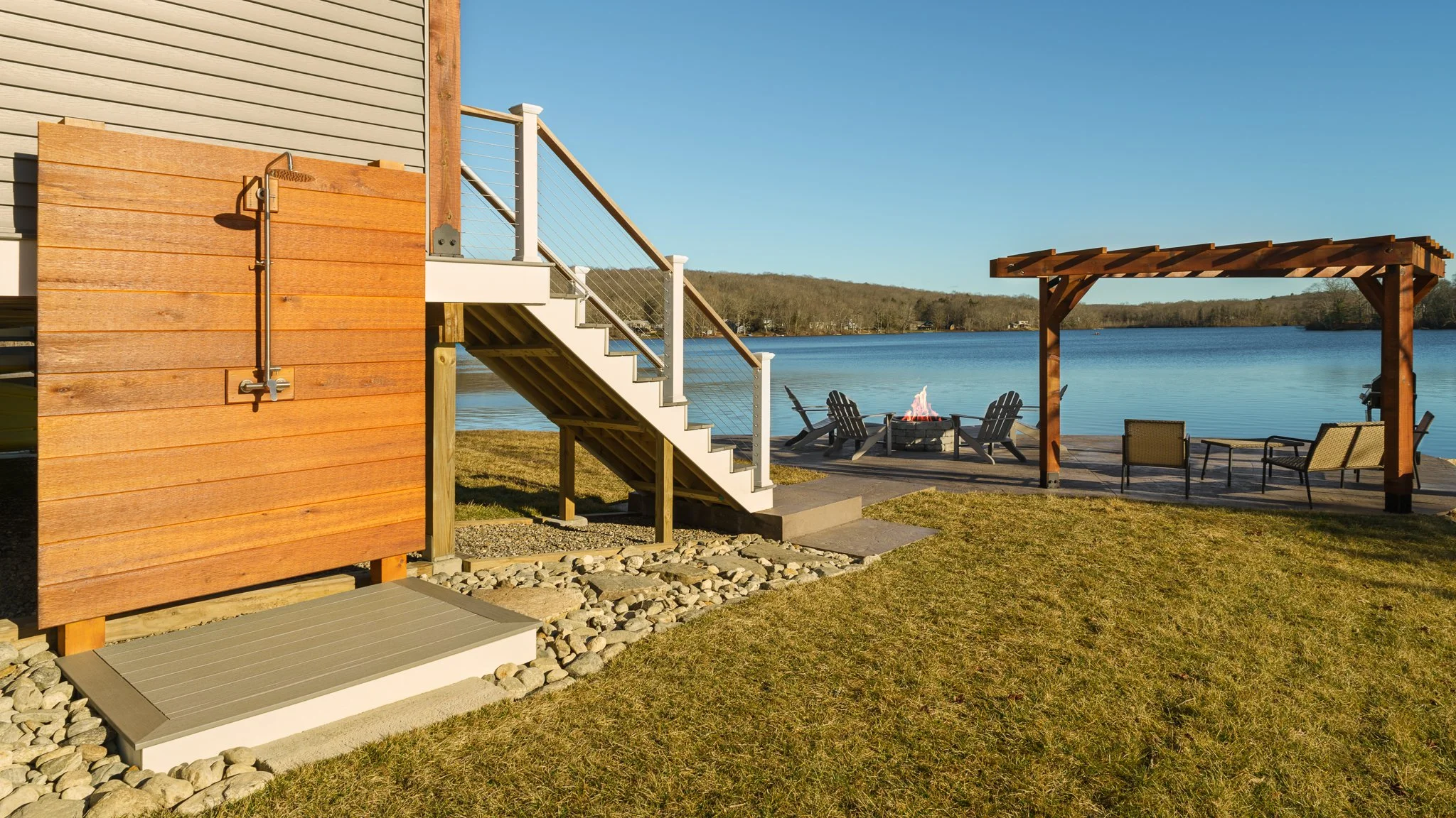 Outdoor shower and deck stairs leading down to the lakefront.