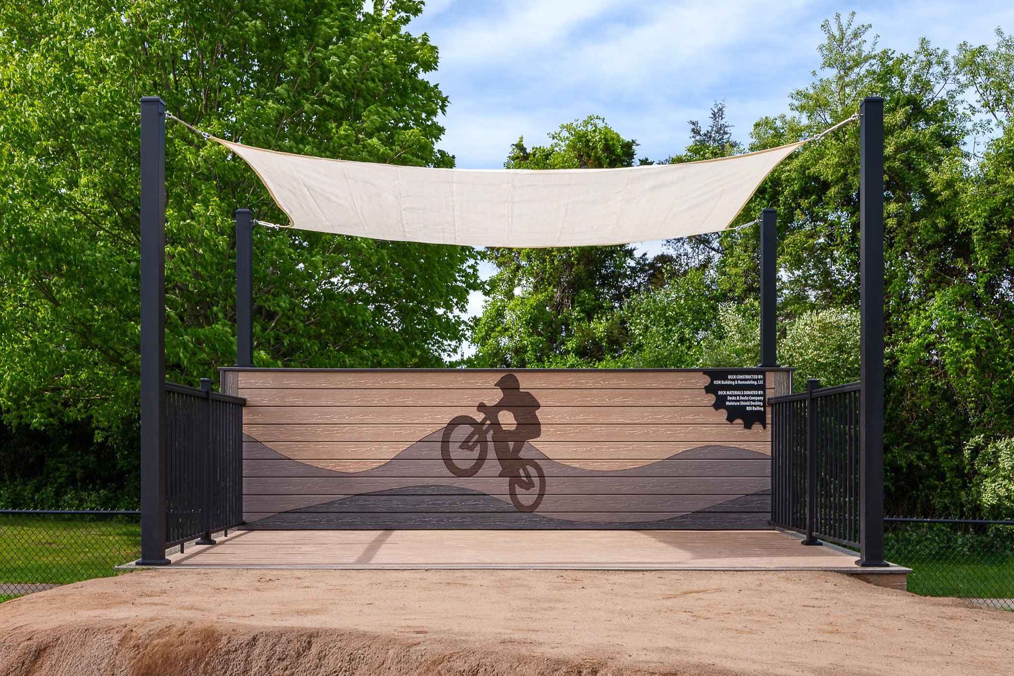 Front elevation of the deck platform with a bike rider silhouette on its back wall.