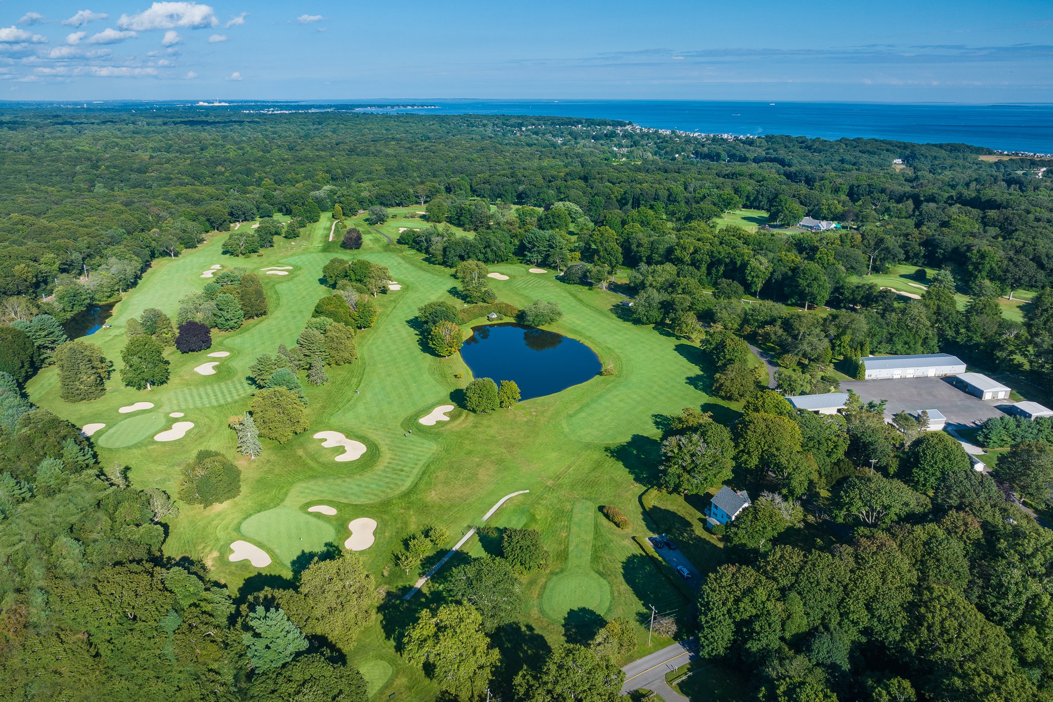 Aerial drone view over the Black Hall Club golf course toward Long Island Sound in Old Lyme, CT.