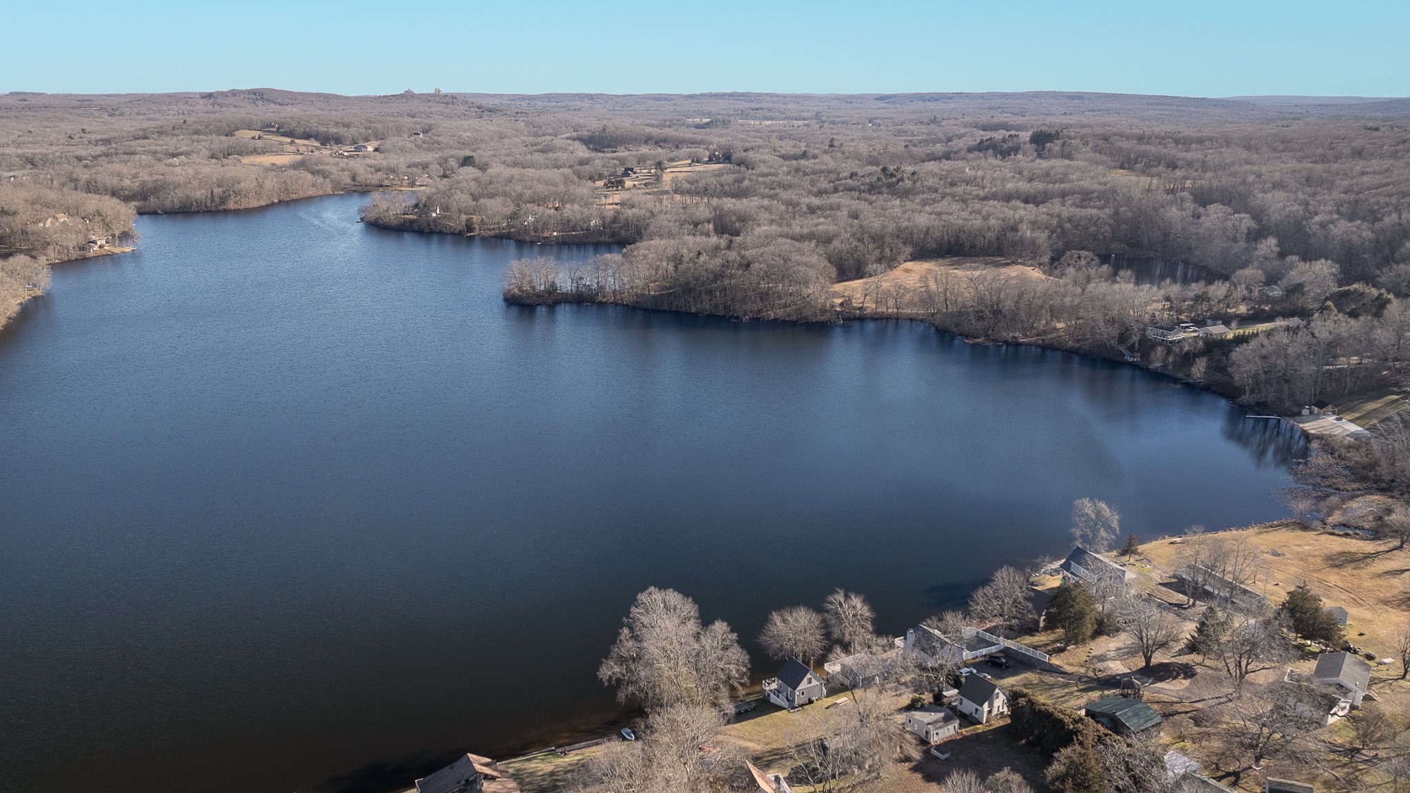 Aerial drone view of Amos Lake with Foxwoods Resort Casino on the horizon.