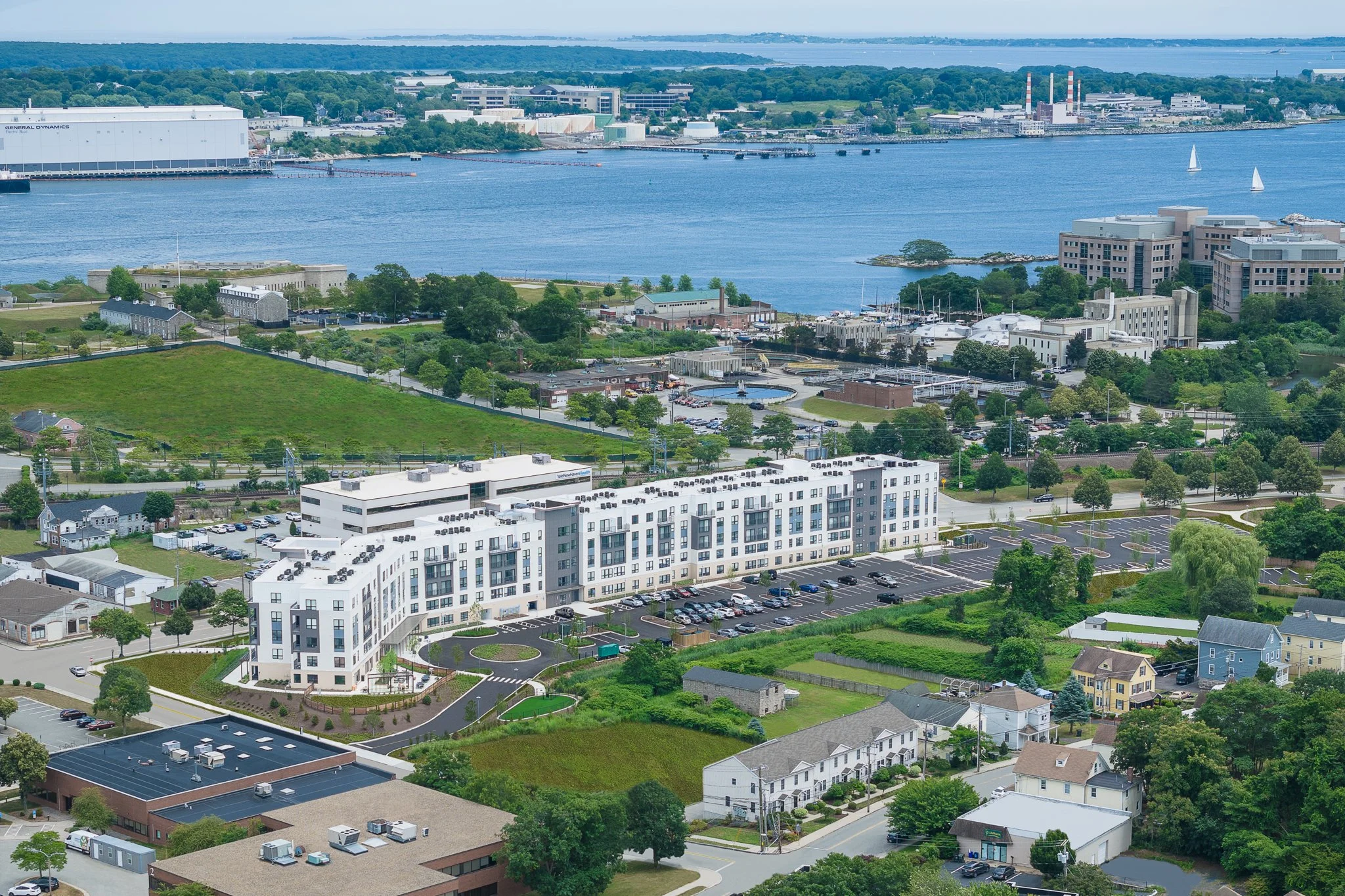 Aerial drone view of the building with the Thames River and Fishers Island on the horizon.