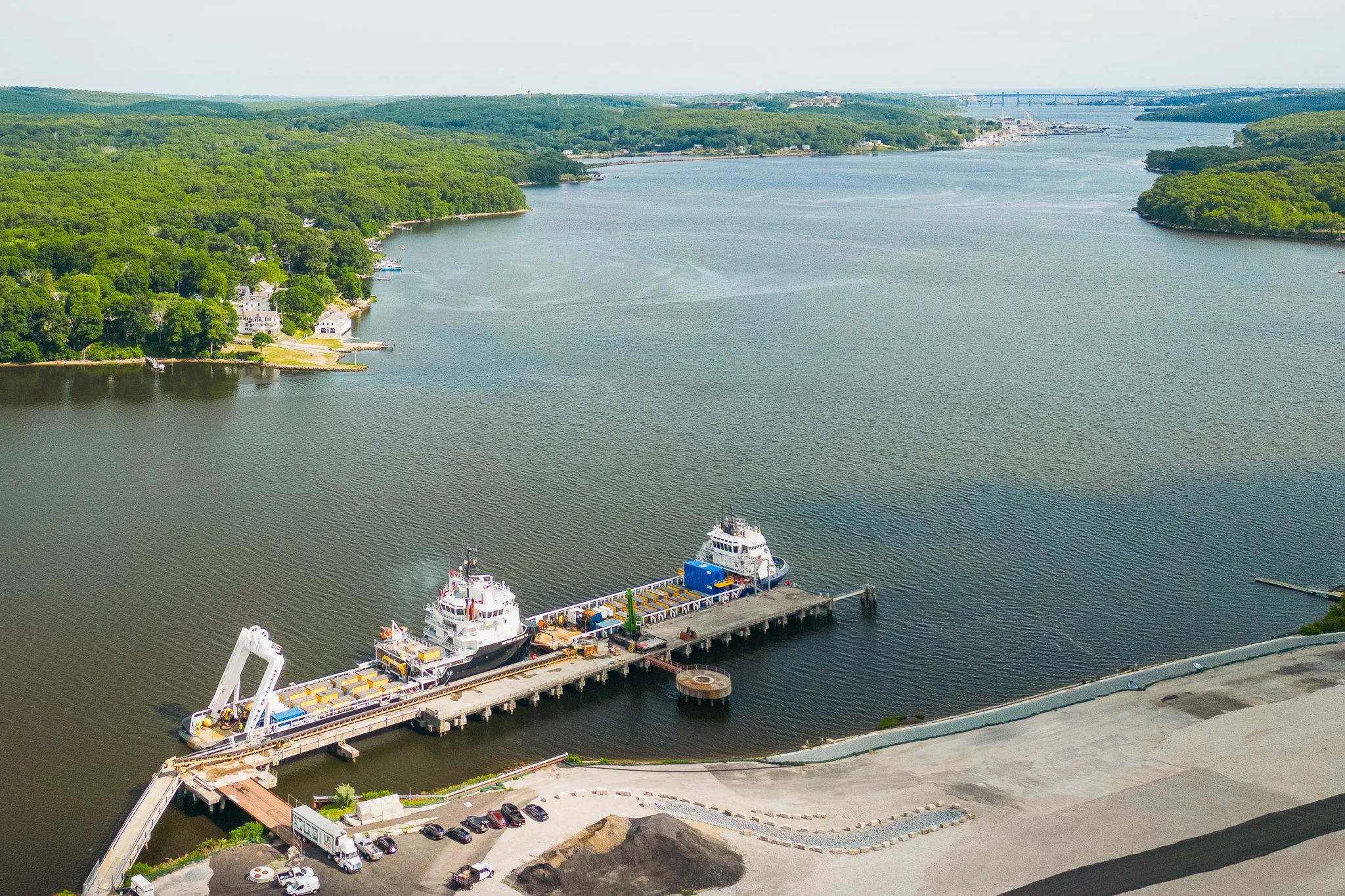 Aerial drone view of the vessels docked along the riverbank.