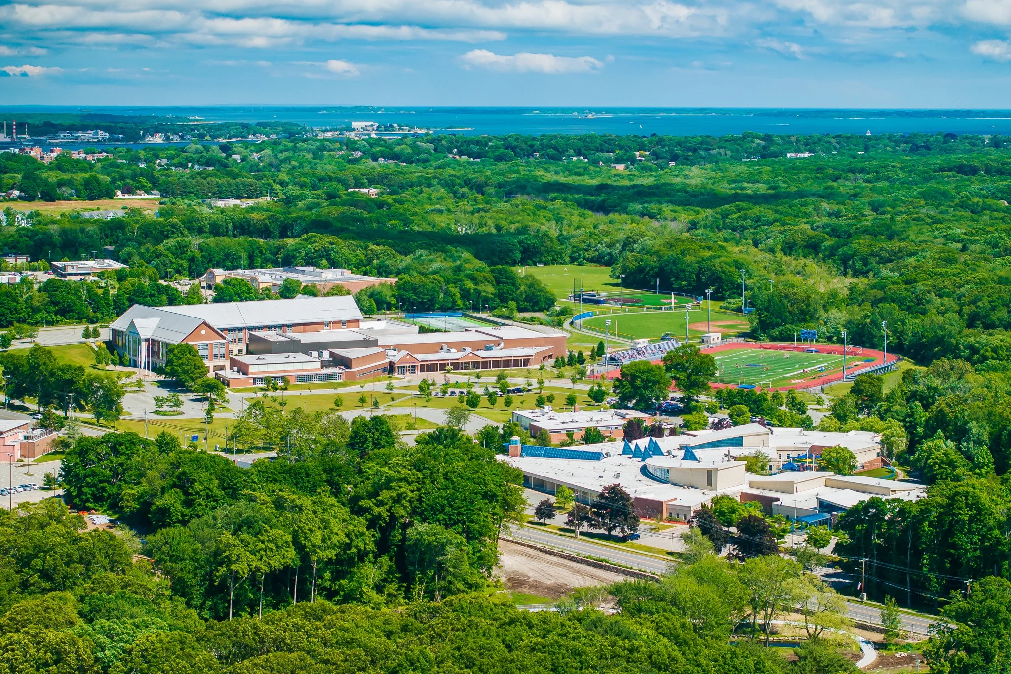 Aerial drone view of the Waterford Community Center and Waterford High School campus with Long Island Sound on the horizon.