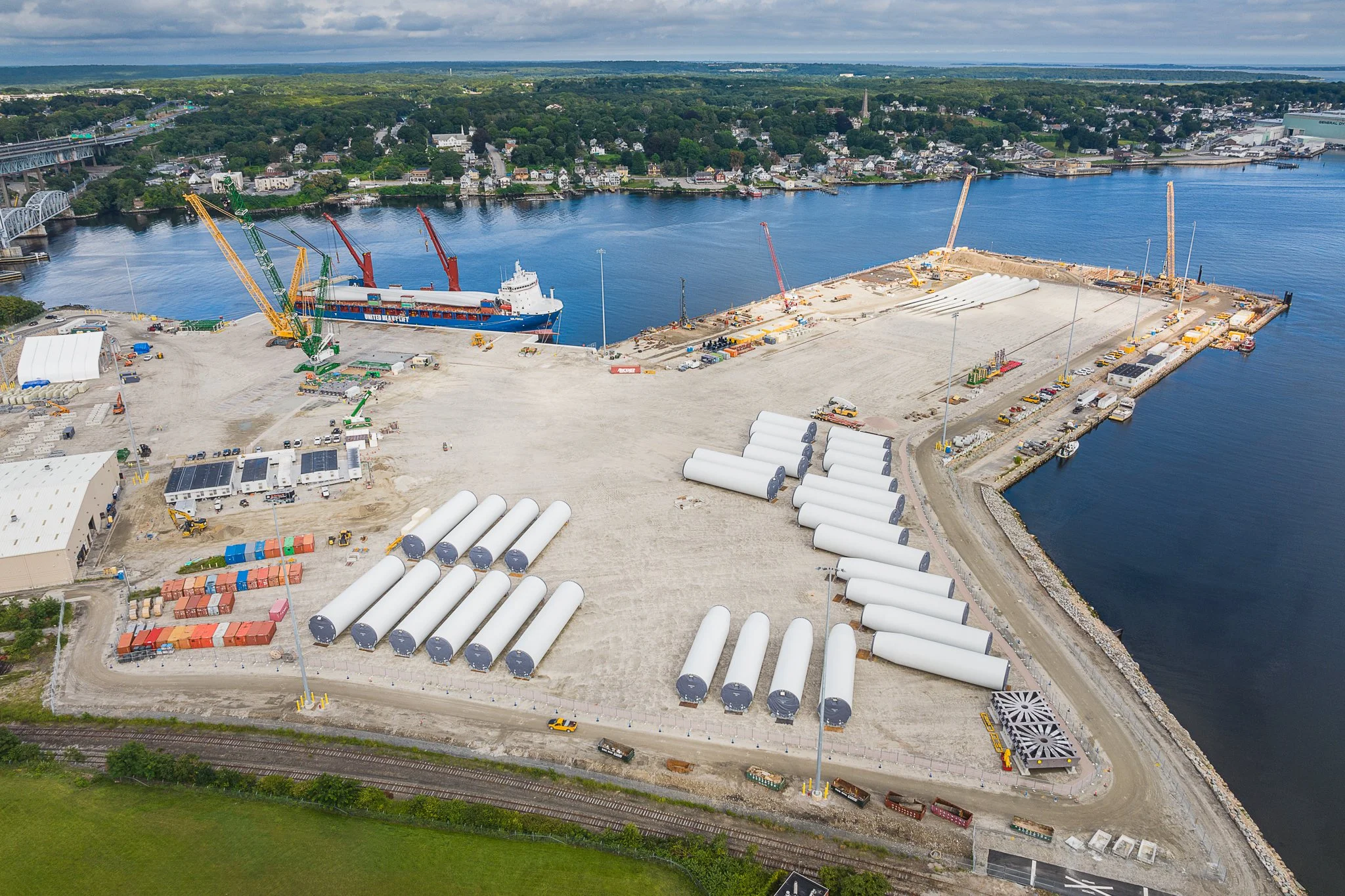 Offshore wind turbine blades staged at New London State Pier, seen by drone.