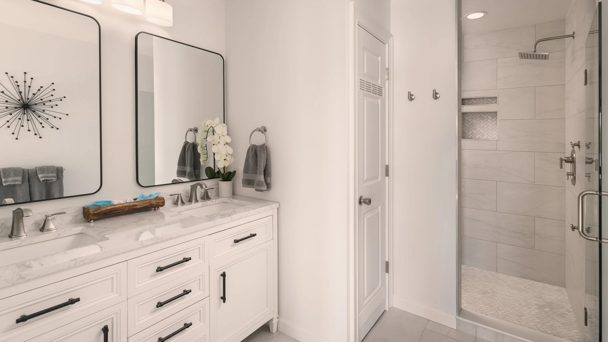 Primary bathroom with a double vanity and walk-in shower.