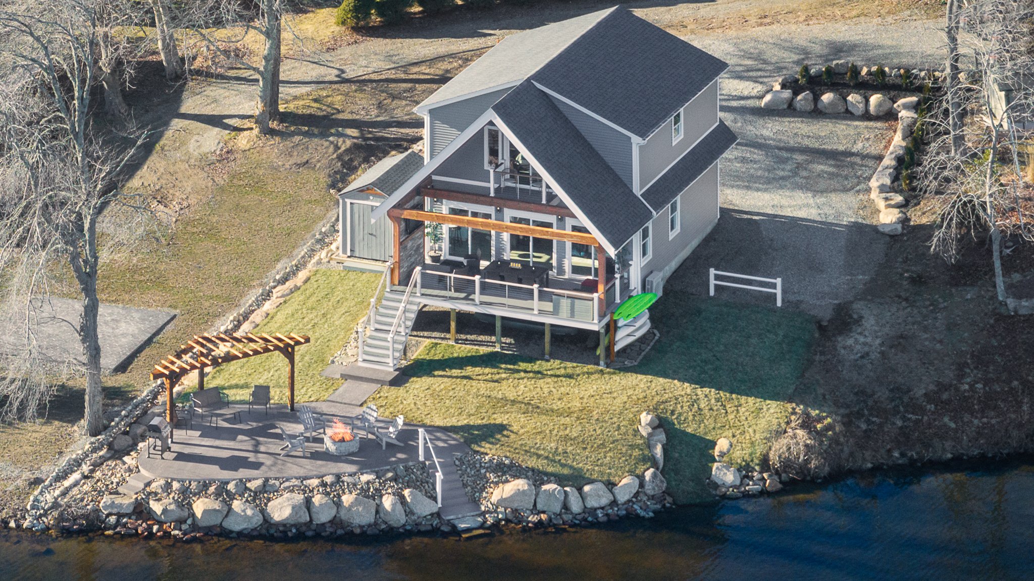 Aerial drone view of the Eagles Nest Airbnb and backyard on the shore of Amos Lake.