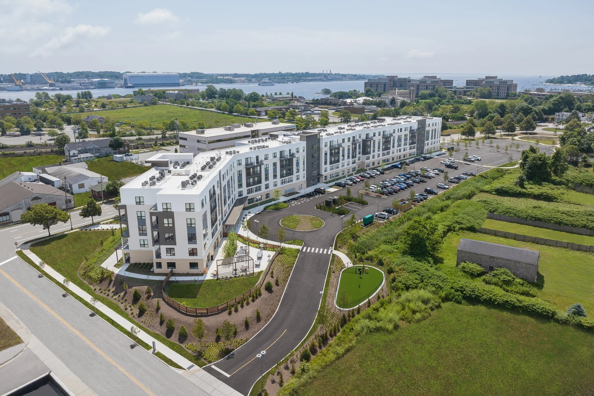 Aerial drone view of the entrance and parking lot with the Thames River beyond.