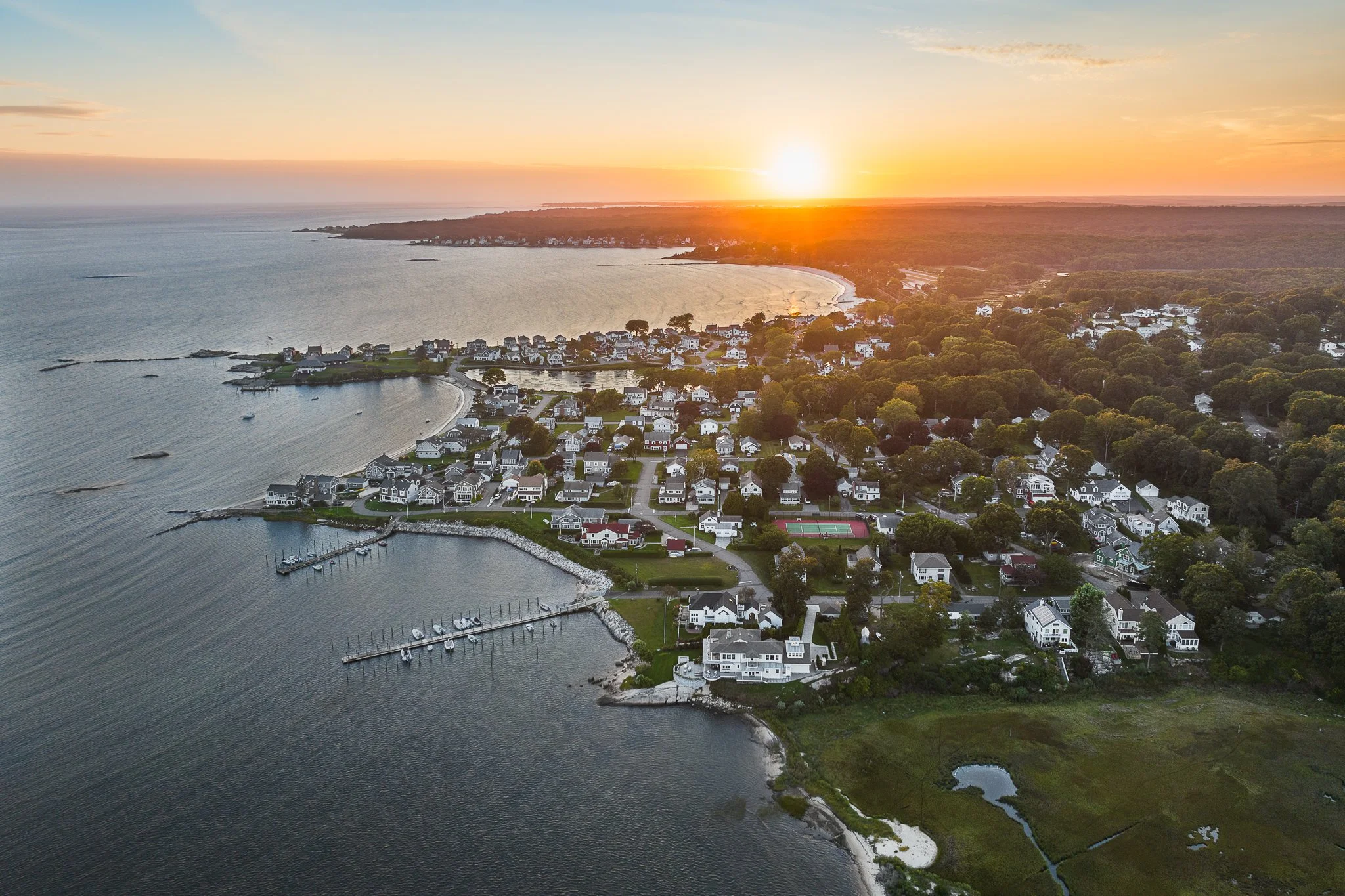 Sunset over the Giants Neck neighborhood with Rocky Neck State Park in the distance, seen by drone.