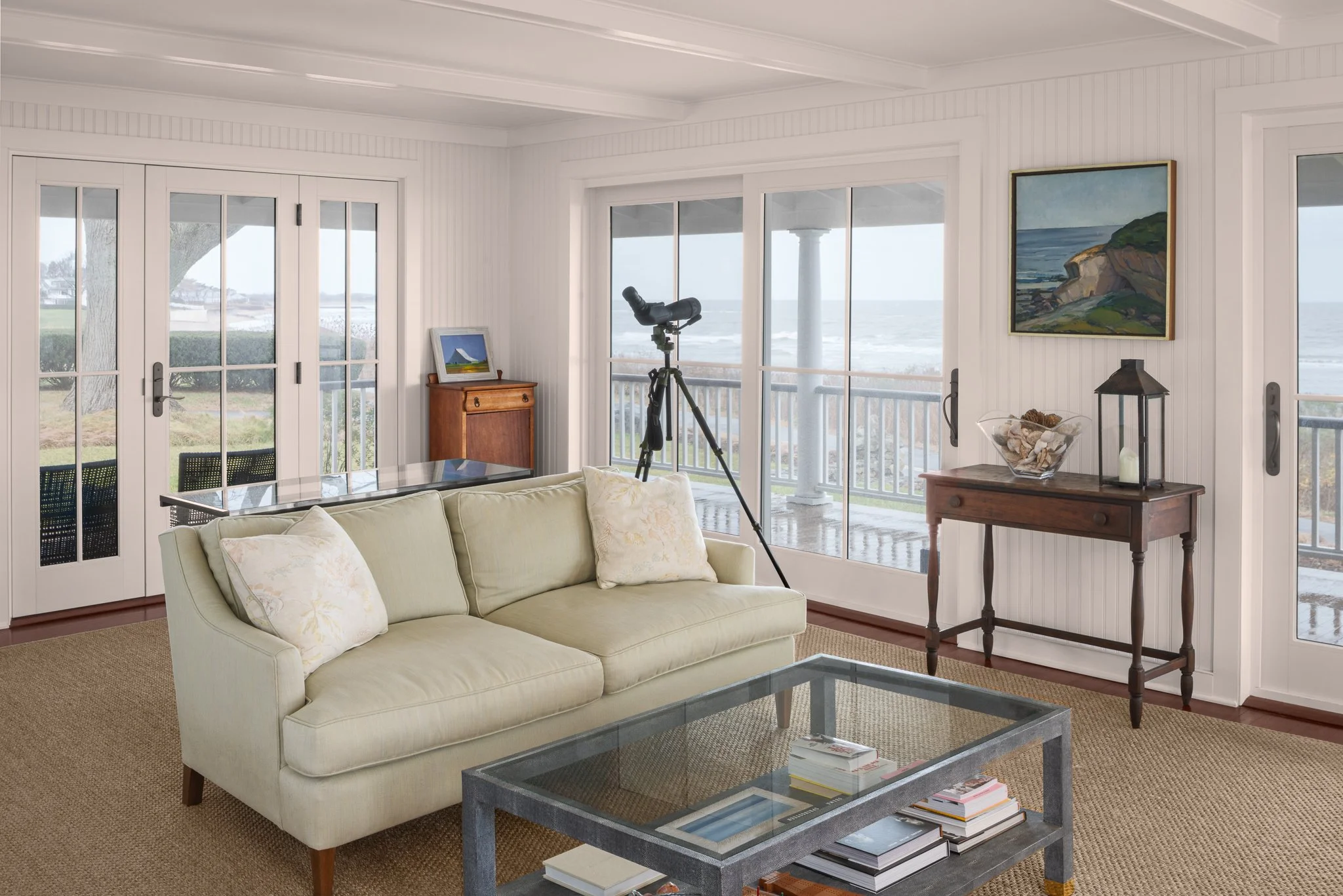 Peggy Sullivan archiect living room with a telescope set up at the windows over Long Island Sound.