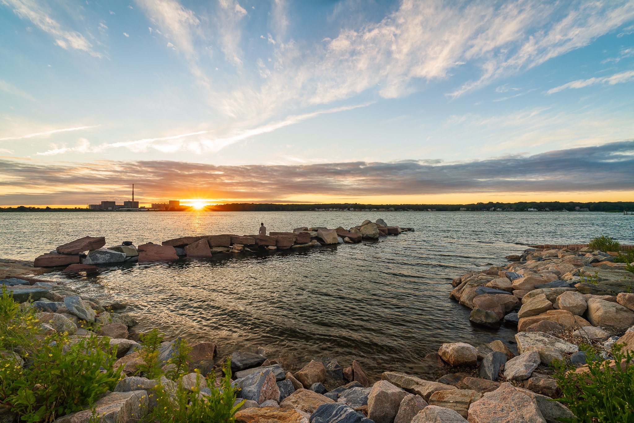 Sunset over the rock jetty at the Pleasure Beach boat launch on Jordan Cove in Waterford, CT.