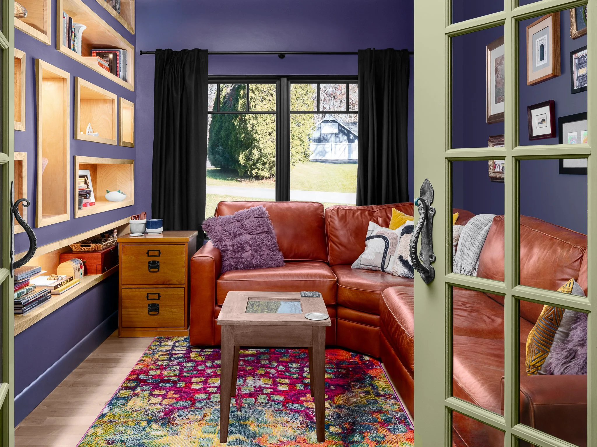 After: finished image of the purple reading nook with its leather sectional and patterned rug.